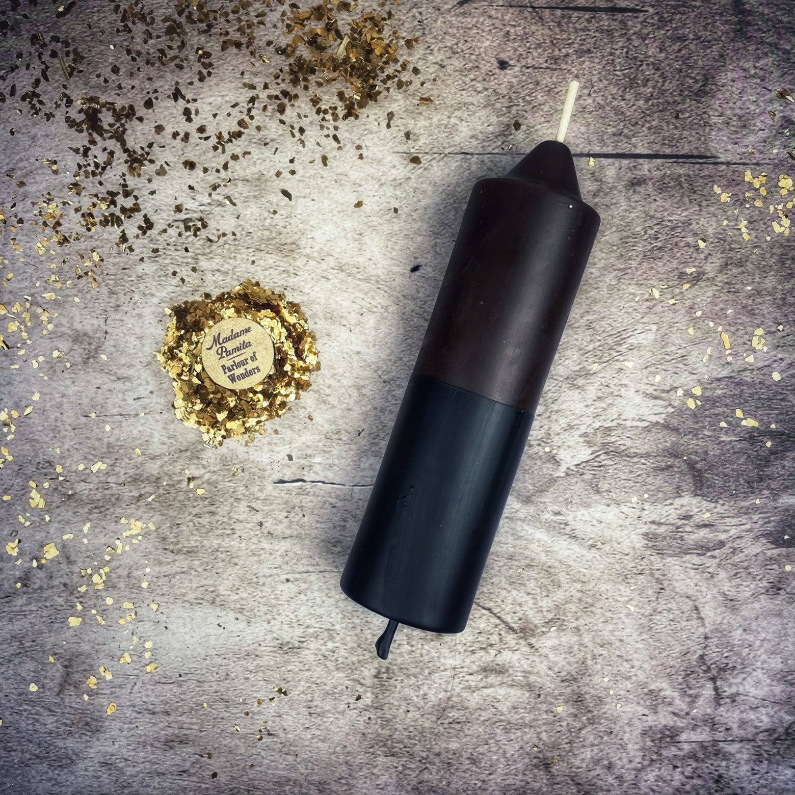 Yellow and black beeswax candle from Parlour of Wonders, designed for protection and curse reversal magic.