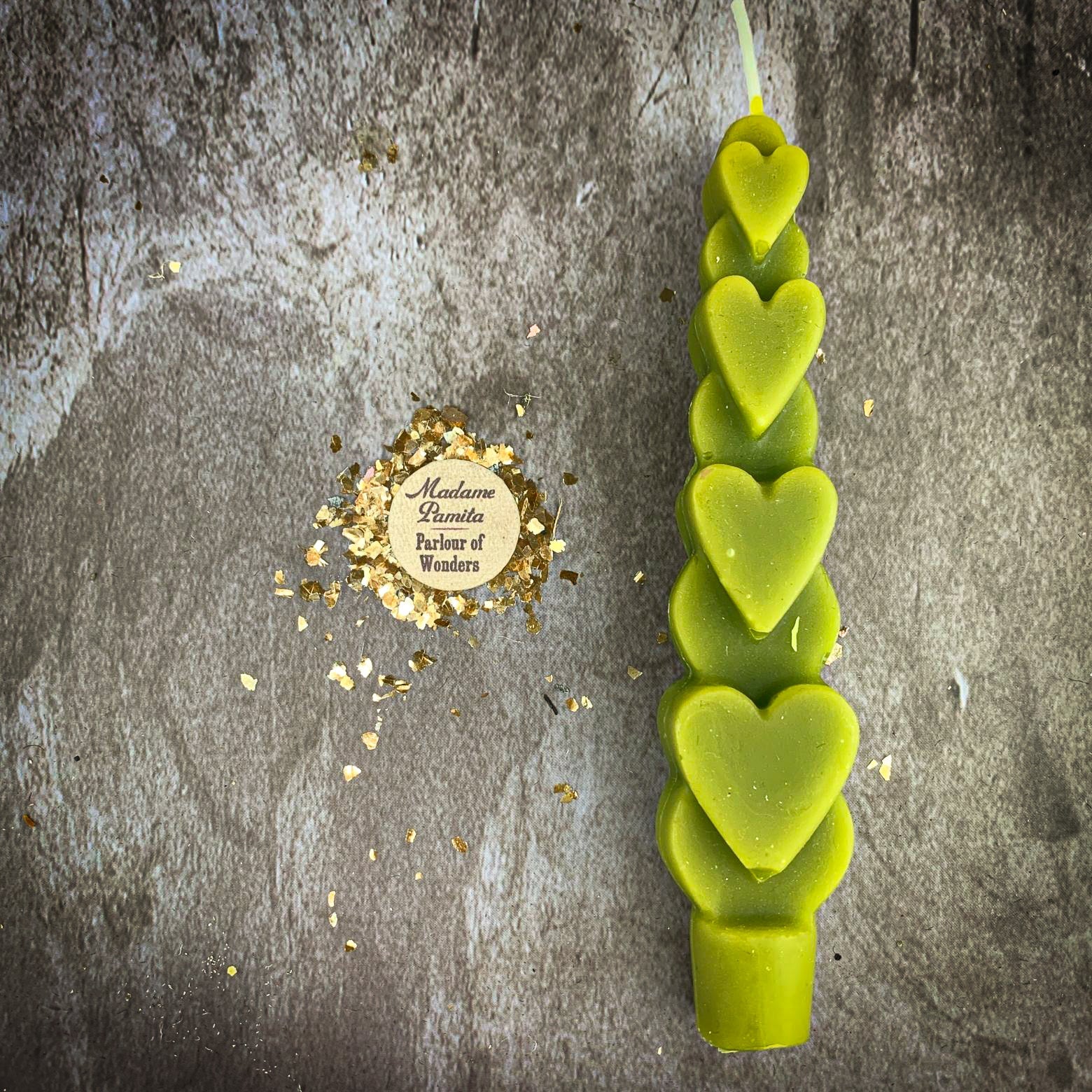 Yellow beeswax love spell heart taper candle by Parlour of Wonders, used for romance and attraction magic.