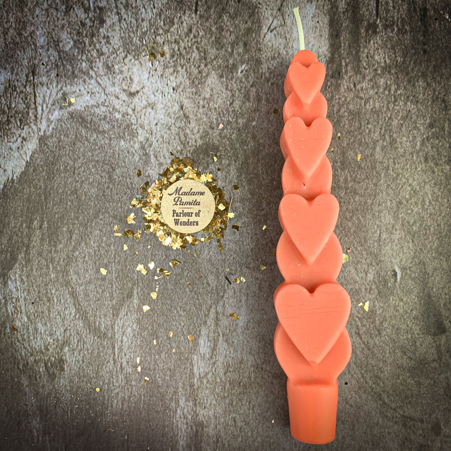Yellow beeswax Love Spell Heart Taper Candle by Parlour of Wonders for romance and attraction magic, with a warm, natural glow.