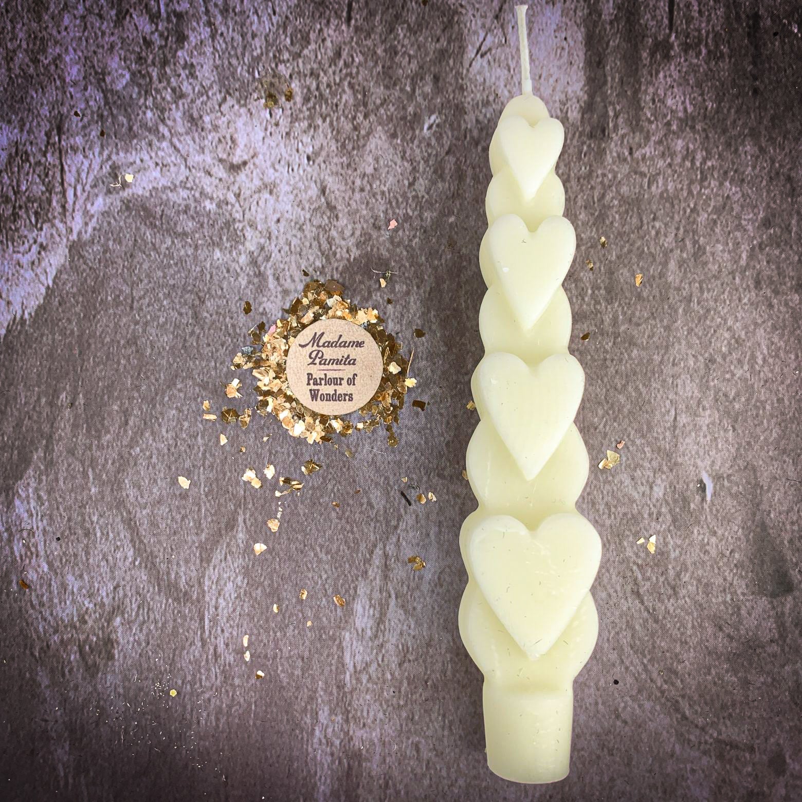 Yellow beeswax love spell heart taper candle by Parlour of Wonders, designed for romance and attraction magic.