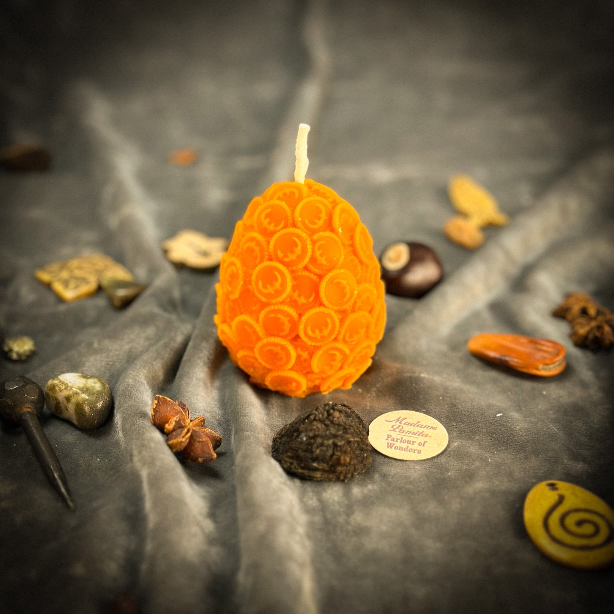 Yellow beeswax nest egg spell candle from Parlour of Wonders, symbolizing savings and financial security.
