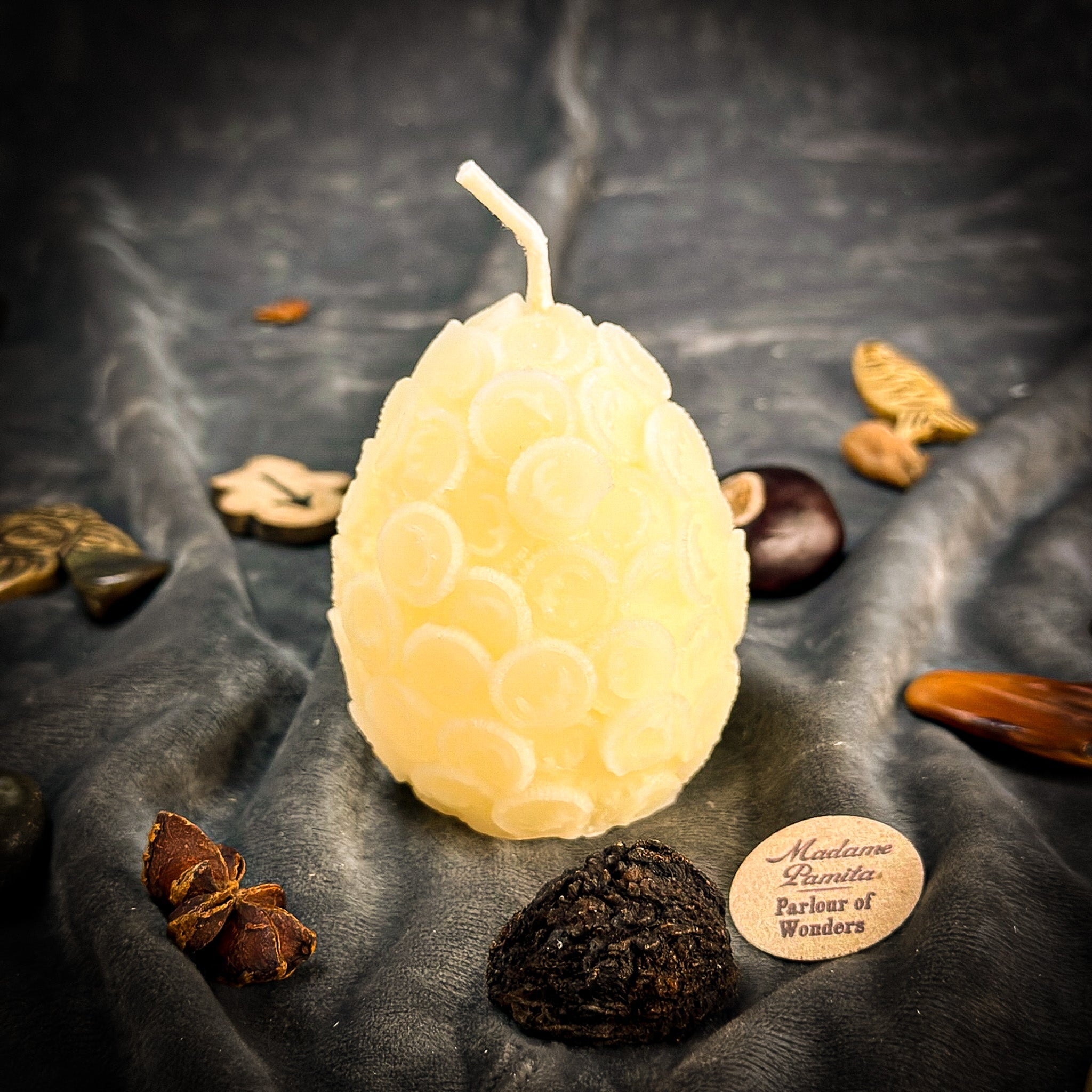 Yellow beeswax nest egg candle by Parlour of Wonders, designed for financial security and savings spells.