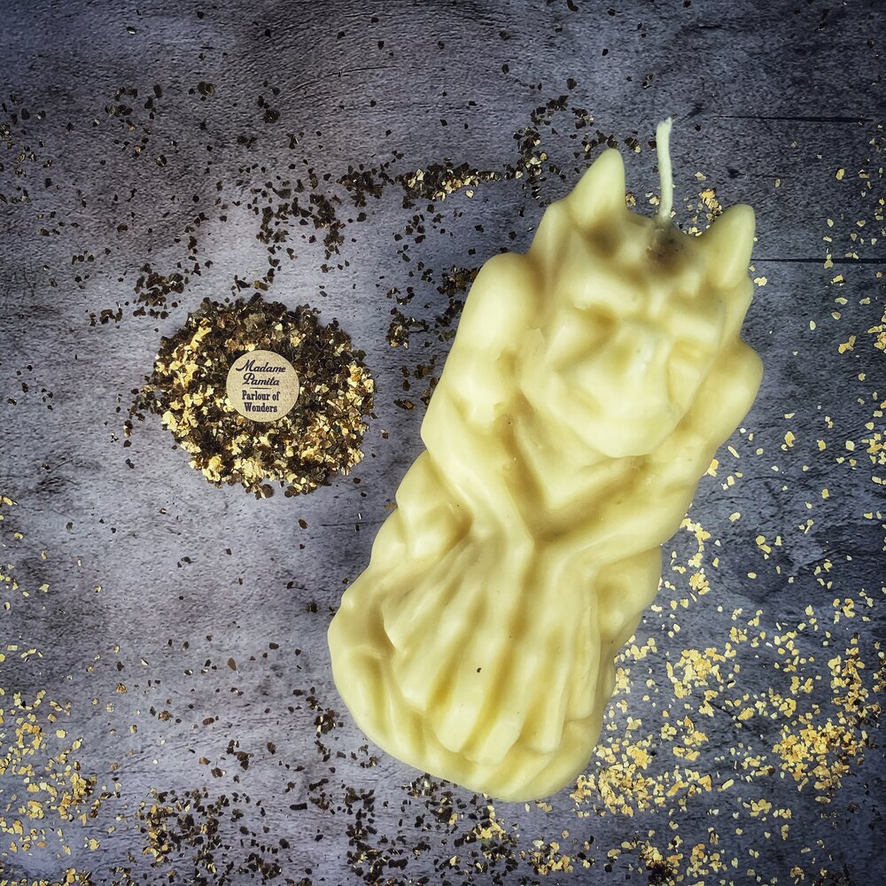Yellow beeswax candle featuring a gargoyle protector design, used for guarding and protection magic by Parlour of Wonders.