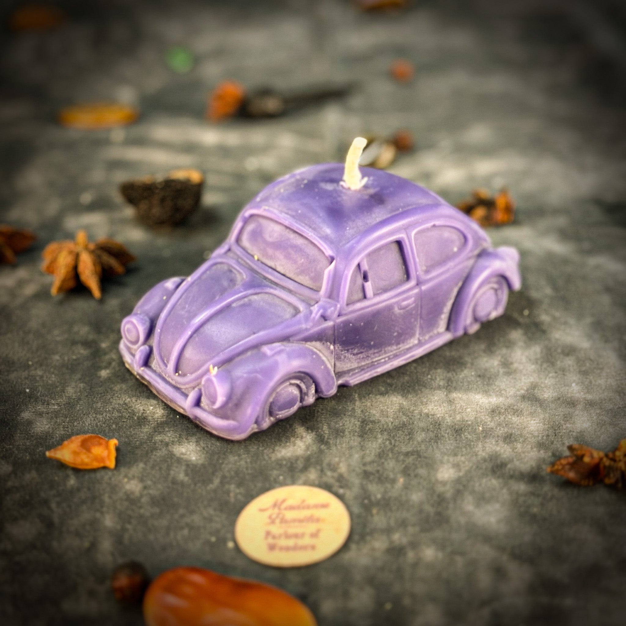 Yellow beeswax candle with charms for safe travels and vehicle protection, by Parlour of Wonders.