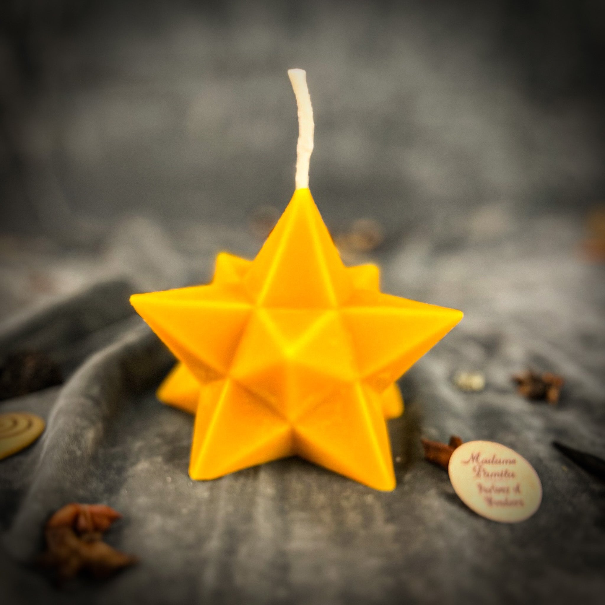 Yellow beeswax candle with pentagram and merkaba symbols, representing protection, ascension, and sacred geometry.