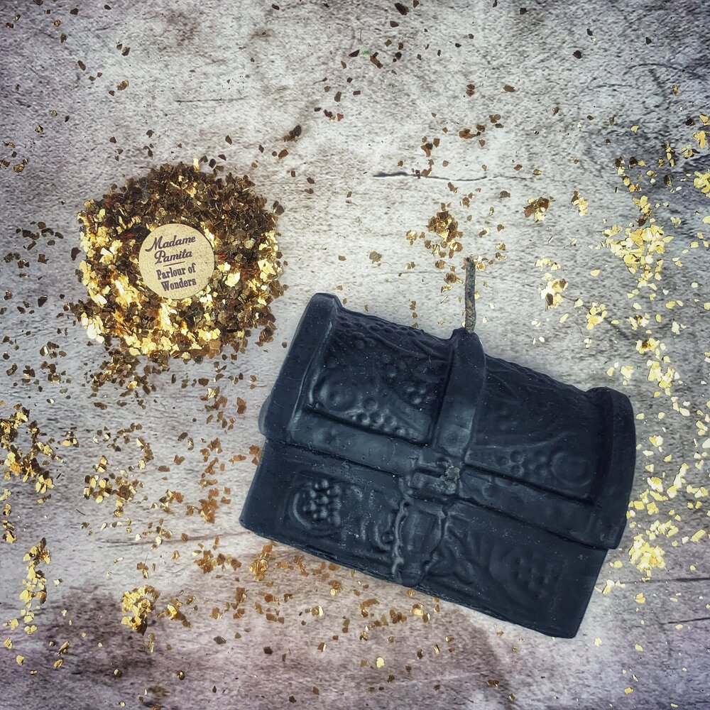 Yellow beeswax candle shaped like a treasure chest by Parlour of Wonders, used for blessings and abundance magic.