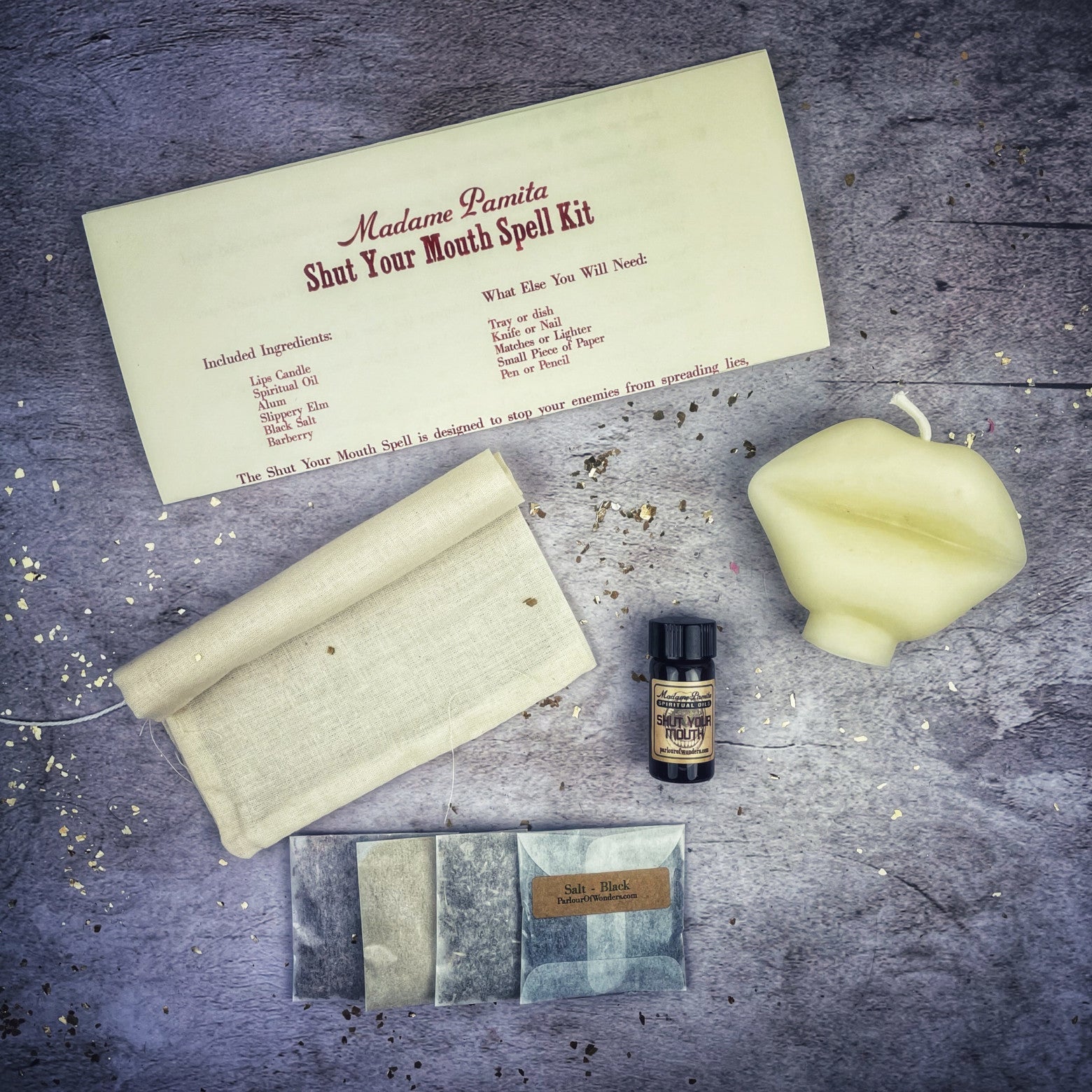 Black candle spell kit by Parlour of Wonders to stop gossip and silence rumors, featuring a firm sealing candle and spell tools.