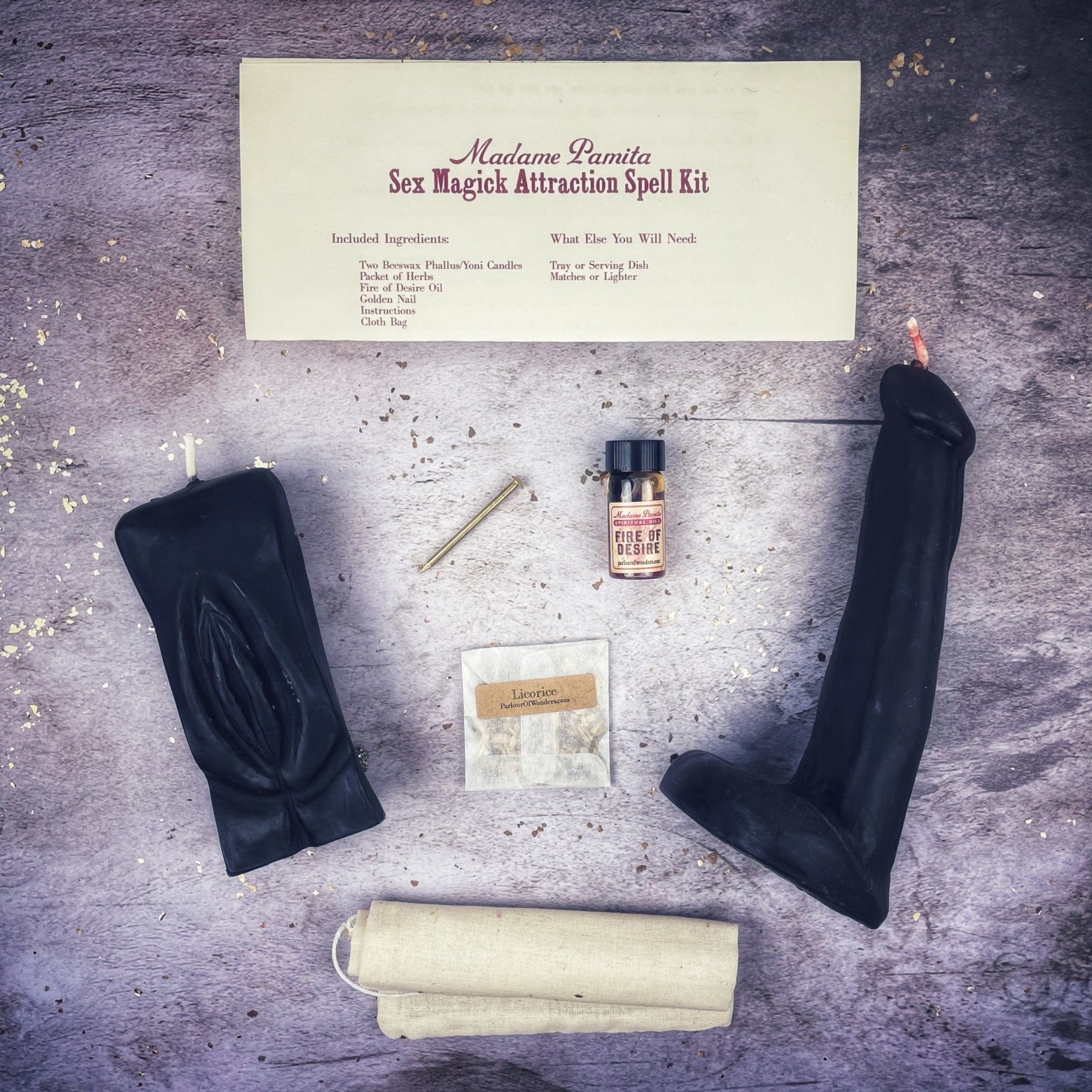 Black candle spell kit by Parlour of Wonders featuring yoni and phallus symbols for passion and attraction magic.