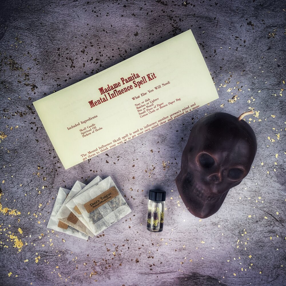 Parlour of Wonders skull candle spell kit with orange wax for mental influence, mind control, and mental clarity rituals.