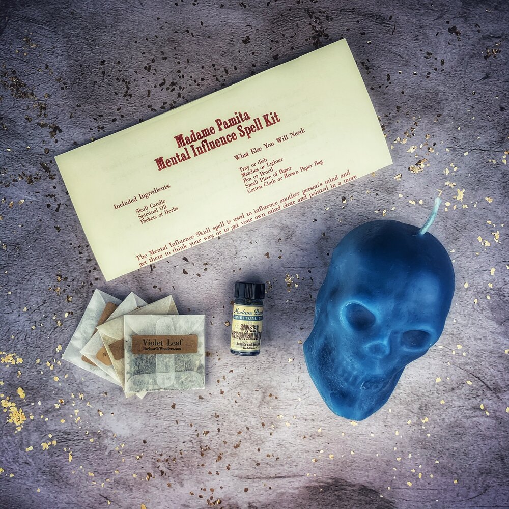 Orange skull-shaped candle from Parlour of Wonders Candle Spell Kit for mental influence, mind control, and mental clarity.
