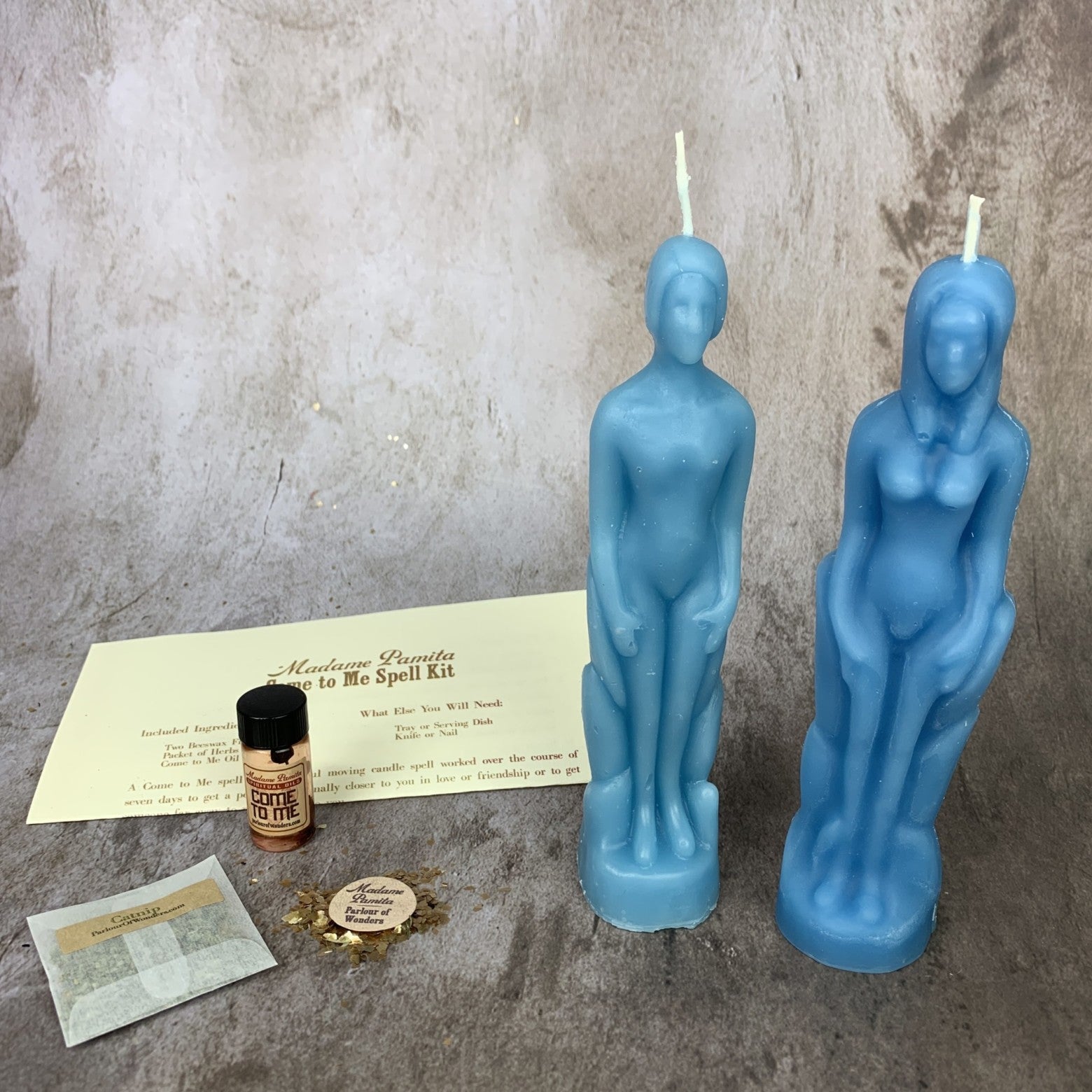 Parlour of Wonders Come to Me Candle Spell Kit with purple candles and human female figure for attracting love and passion.