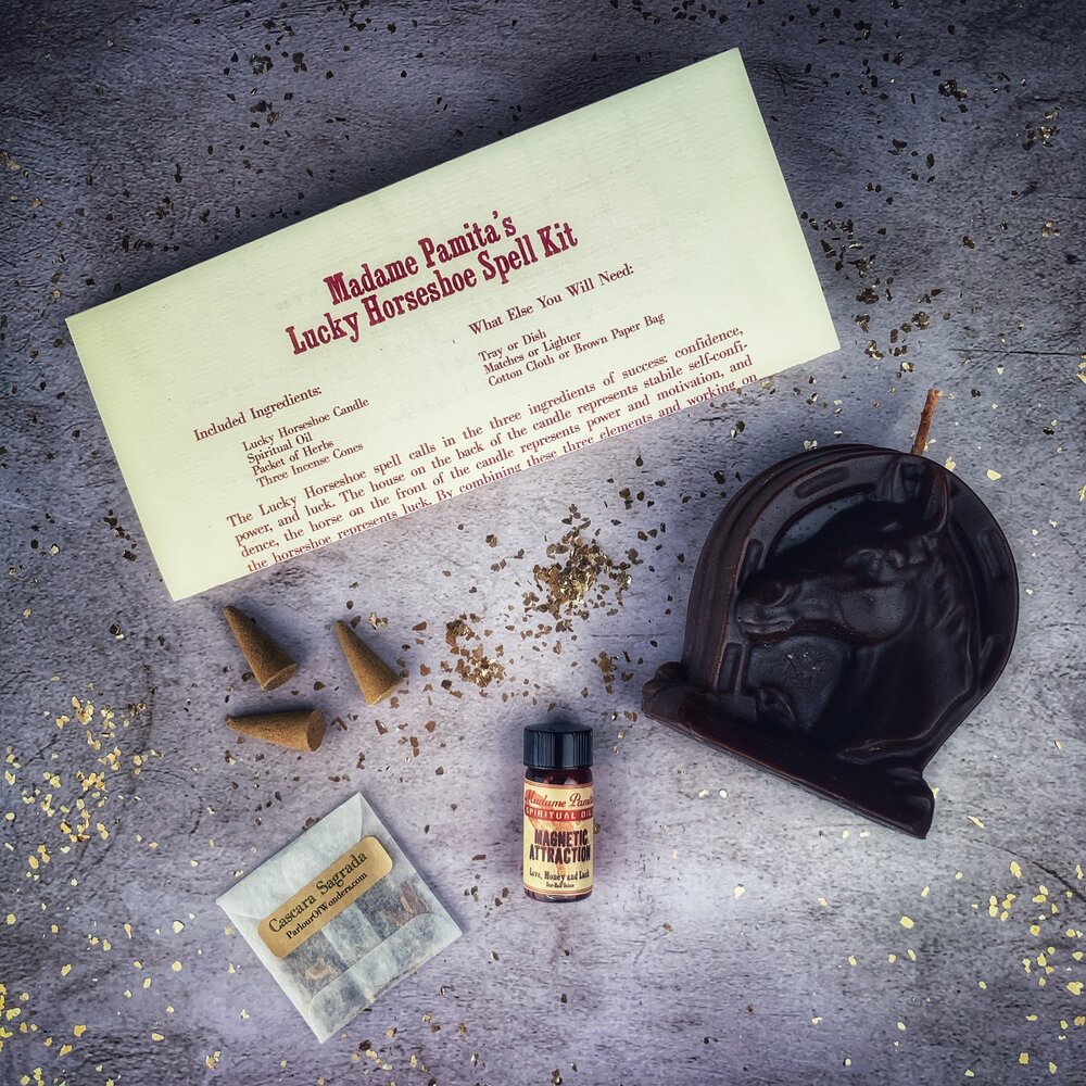 Red Lucky Horseshoe Candle Spell Kit from Parlour of Wonders, featuring candles and charms for luck and power magic.
