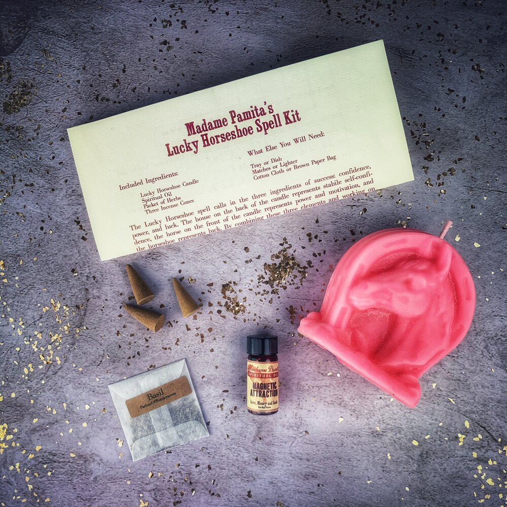 Red Lucky Horseshoe Candle Spell Kit by Parlour of Wonders featuring candles and magic tools for luck and power spells.