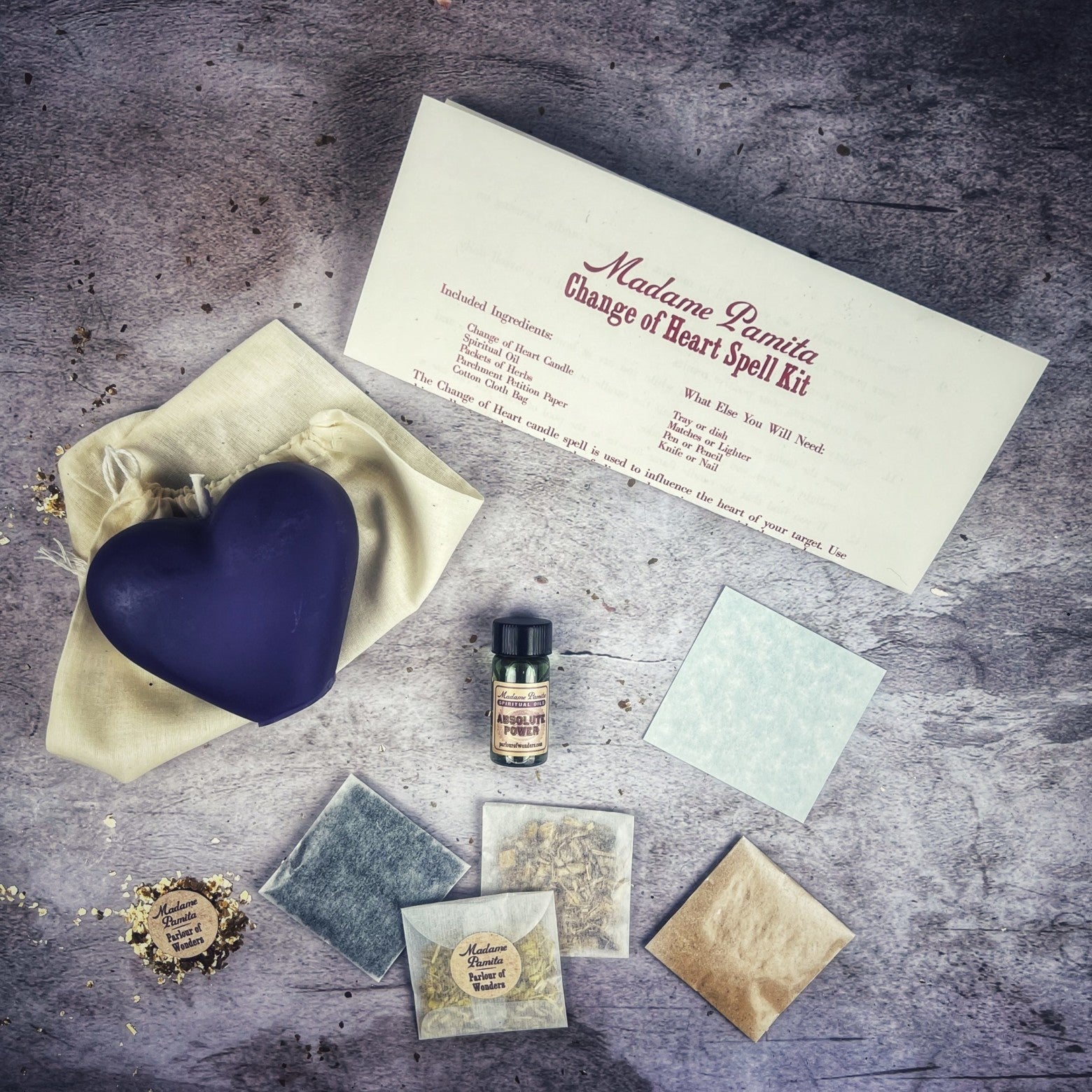 Red candle spell kit from Parlour of Wonders for love reconciliation and emotional healing, with herbs and tools for spiritual practice.