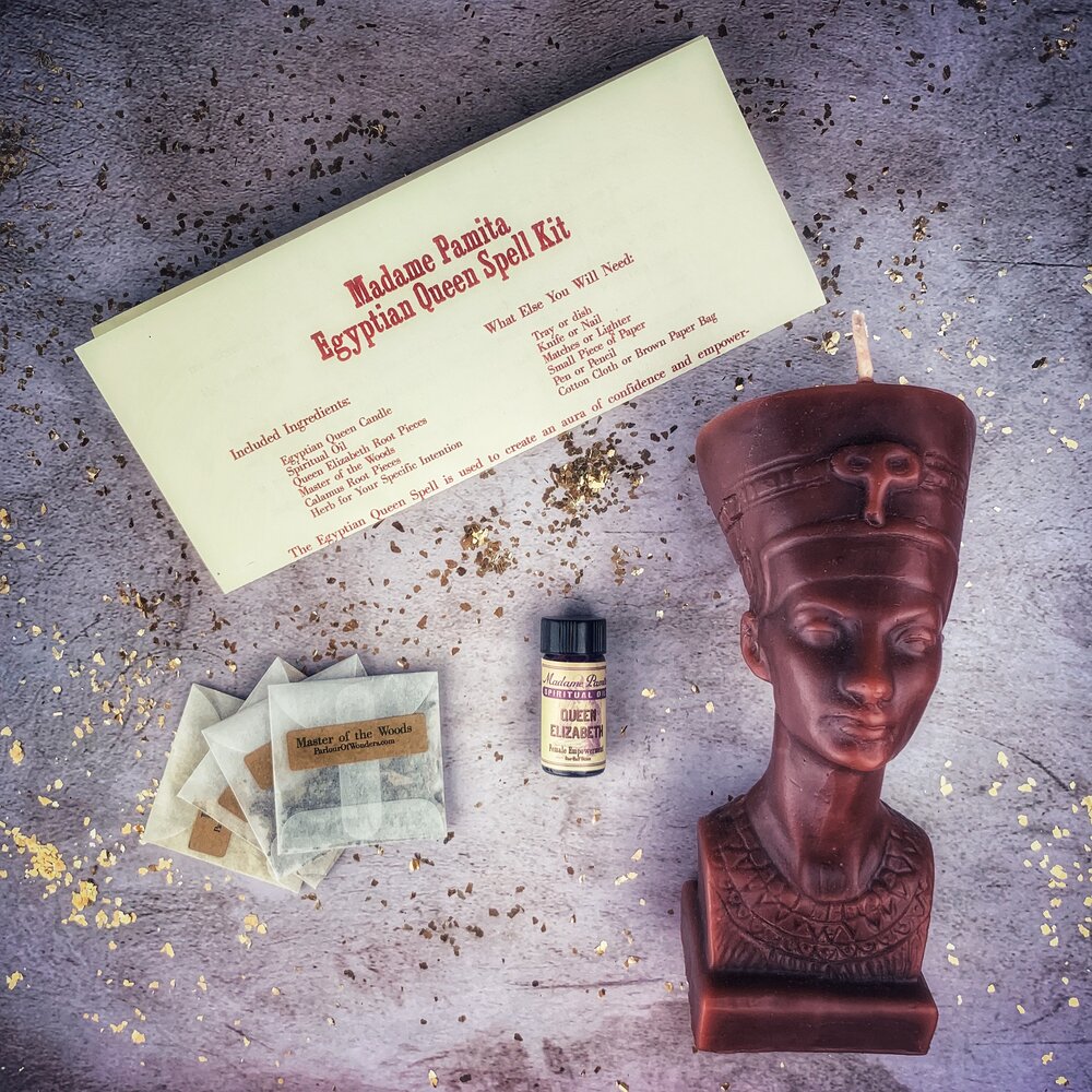 Egyptian Queen Candle Spell Kit by Parlour of Wonders, featuring red candles and ritual tools for power, beauty, and magnetism magic.