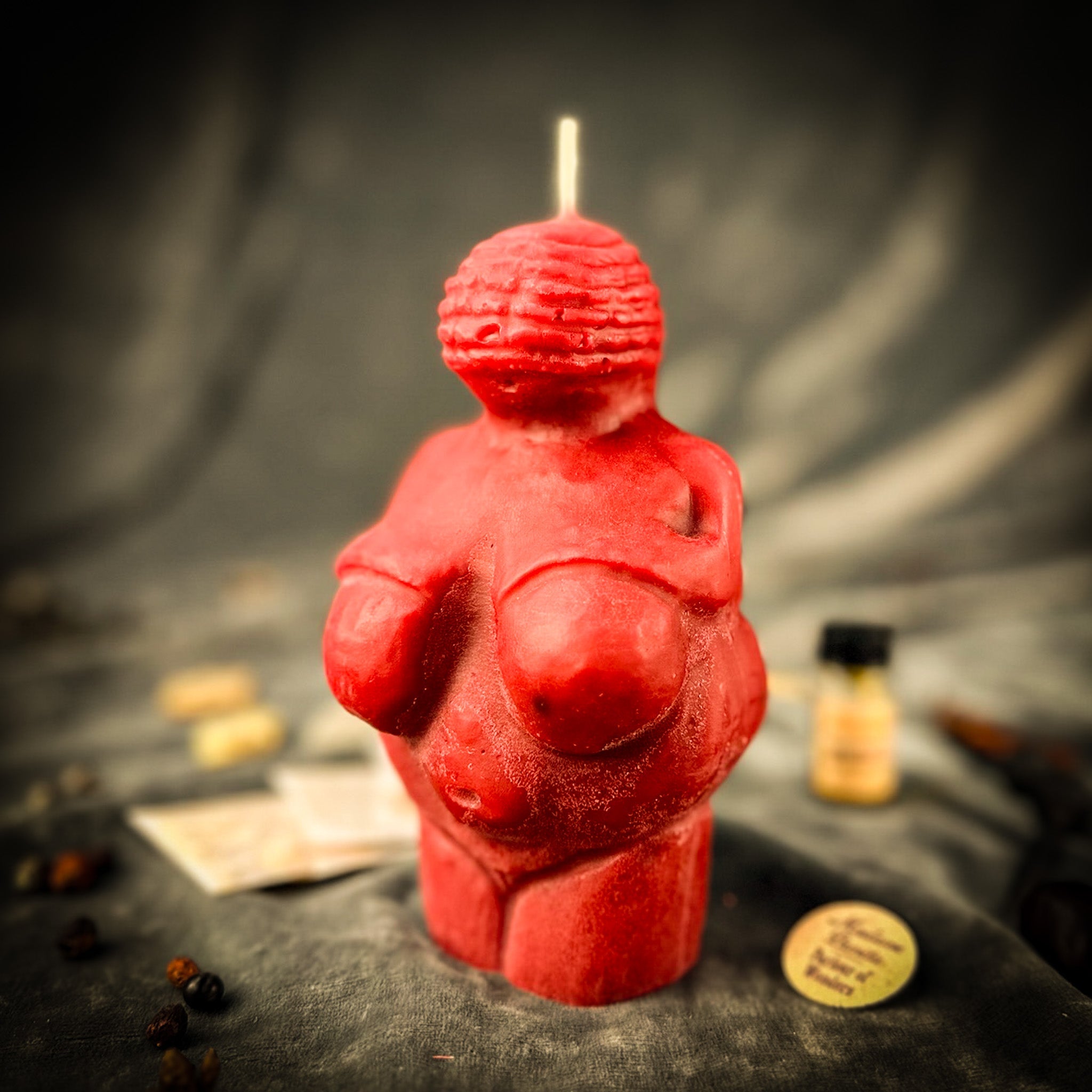 Parlour of Wonders Goddess of Willendorf Candle Spell Kit with red candles, symbols of feminine power and fertility magic.
