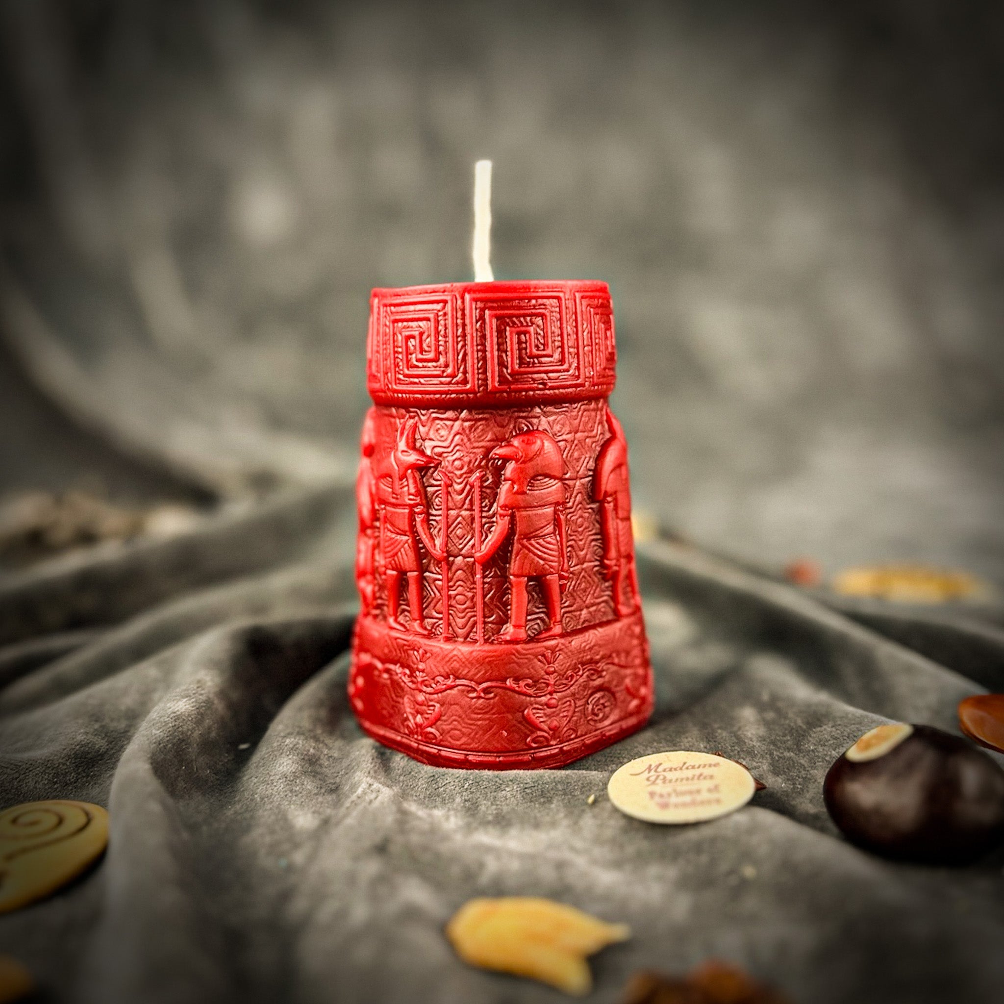 Egyptian pillar candle spell kit featuring Anubis and Horus for protection and divine guidance, with yellow candles and ritual tools.
