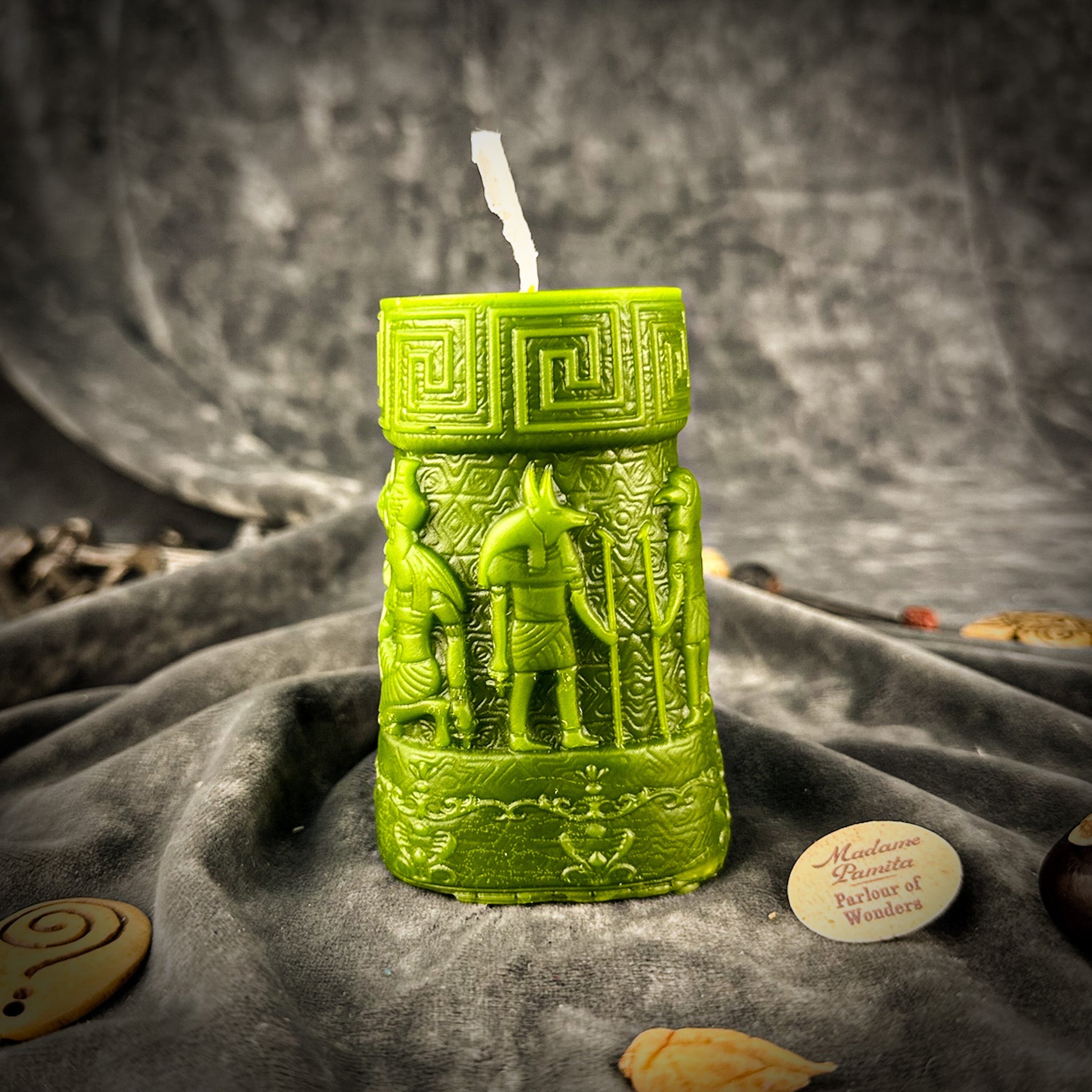 Egyptian pillar candle spell kit featuring Anubis and Horus for protection and divine guidance, with yellow candles and symbolic imagery.
