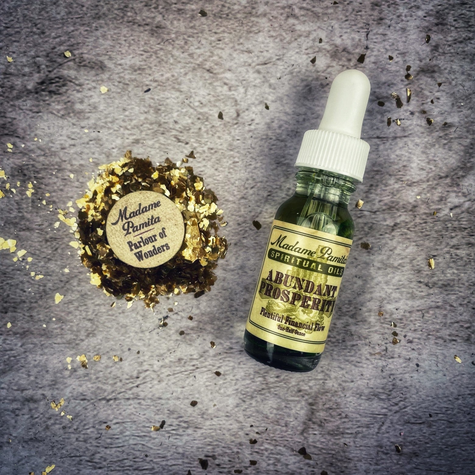 Bottle of Abundant Prosperity Oil by Madame Pamita from Parlour of Wonders, featuring a clear glass container with a golden-colored oil.