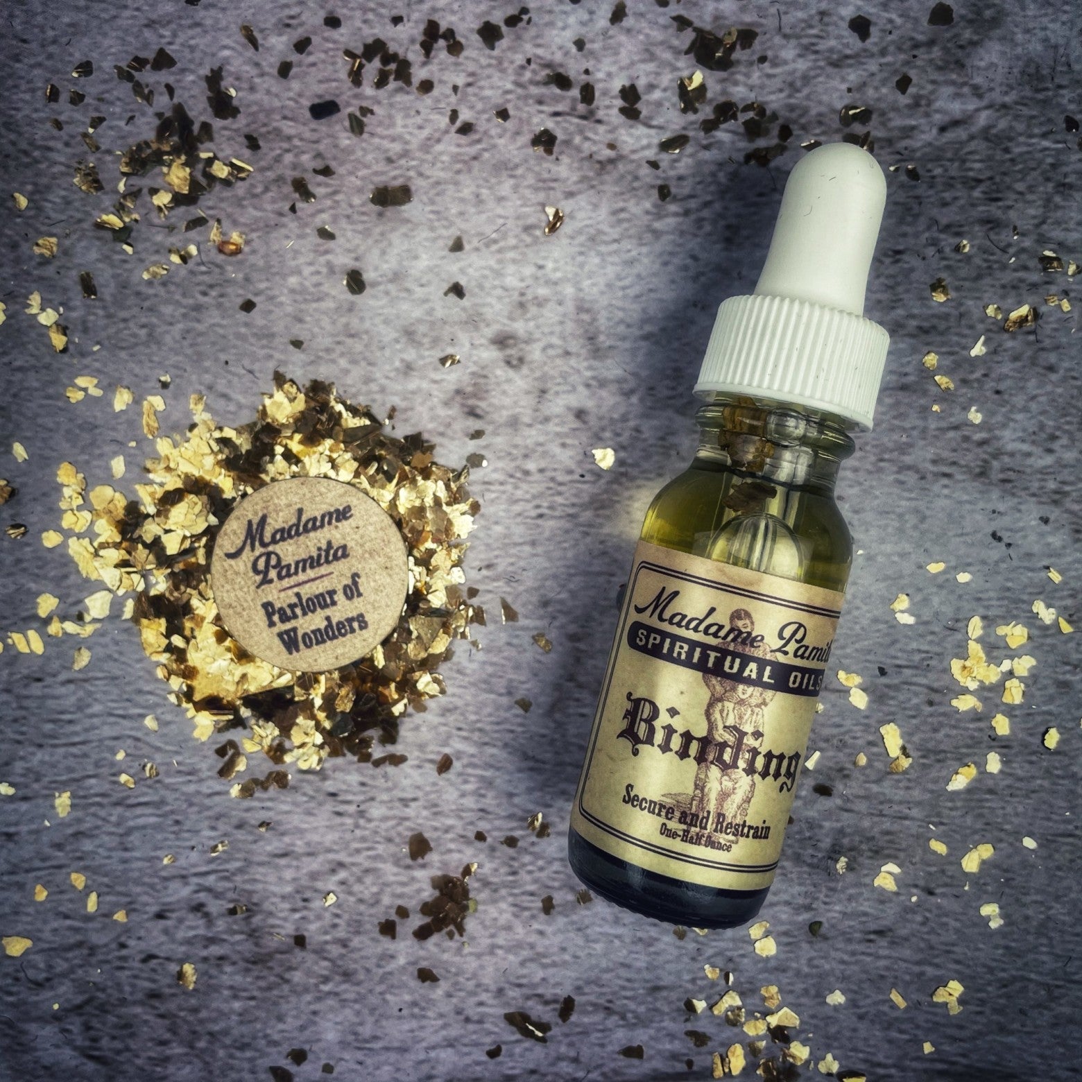 Binding Oil by Madame Pamita, packaged in a small glass bottle with dropper, used for spiritual and ritual purposes.
