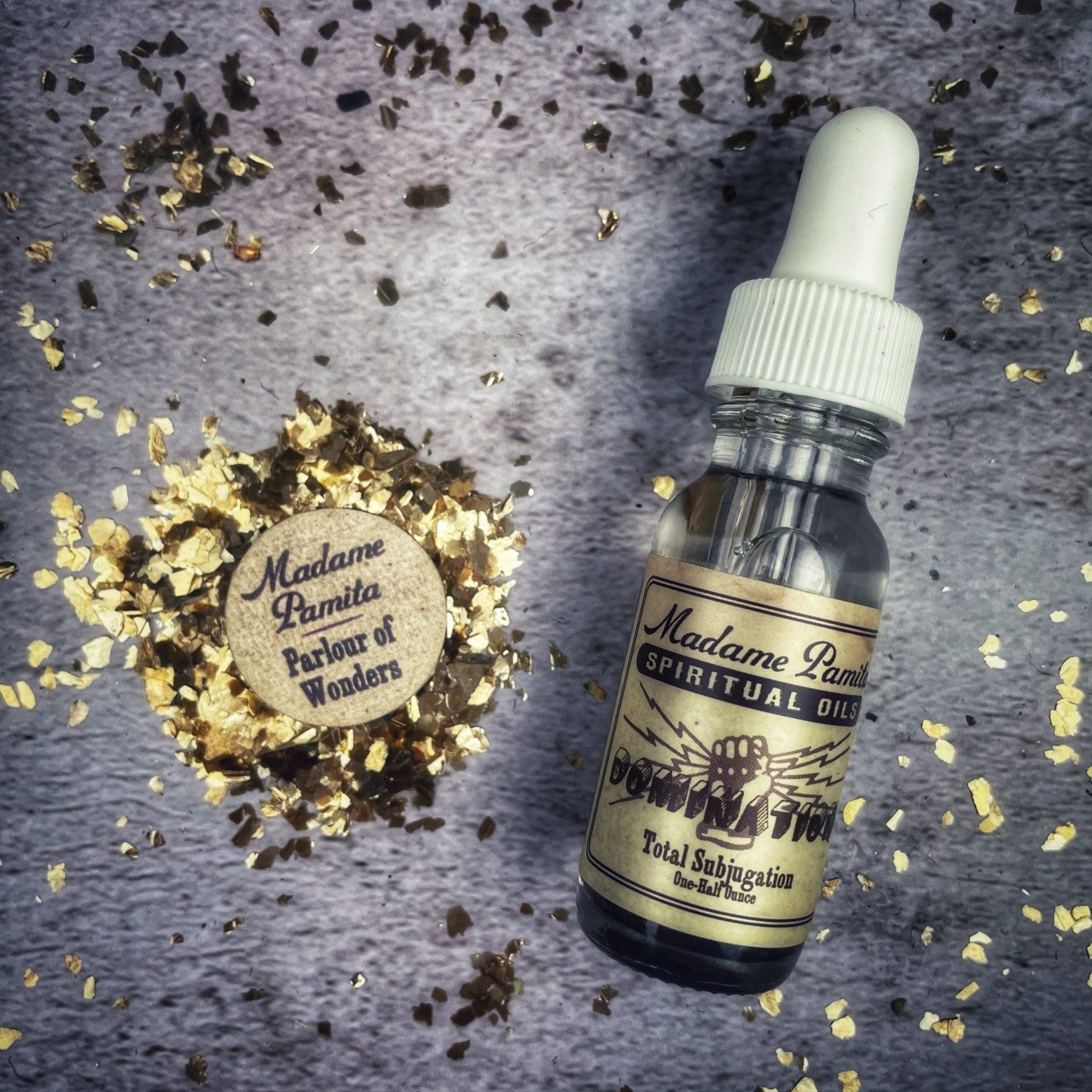 Bottle of Domination Oil by Madame Pamita from Parlour of Wonders, featuring dark amber glass with a label and dropper cap.