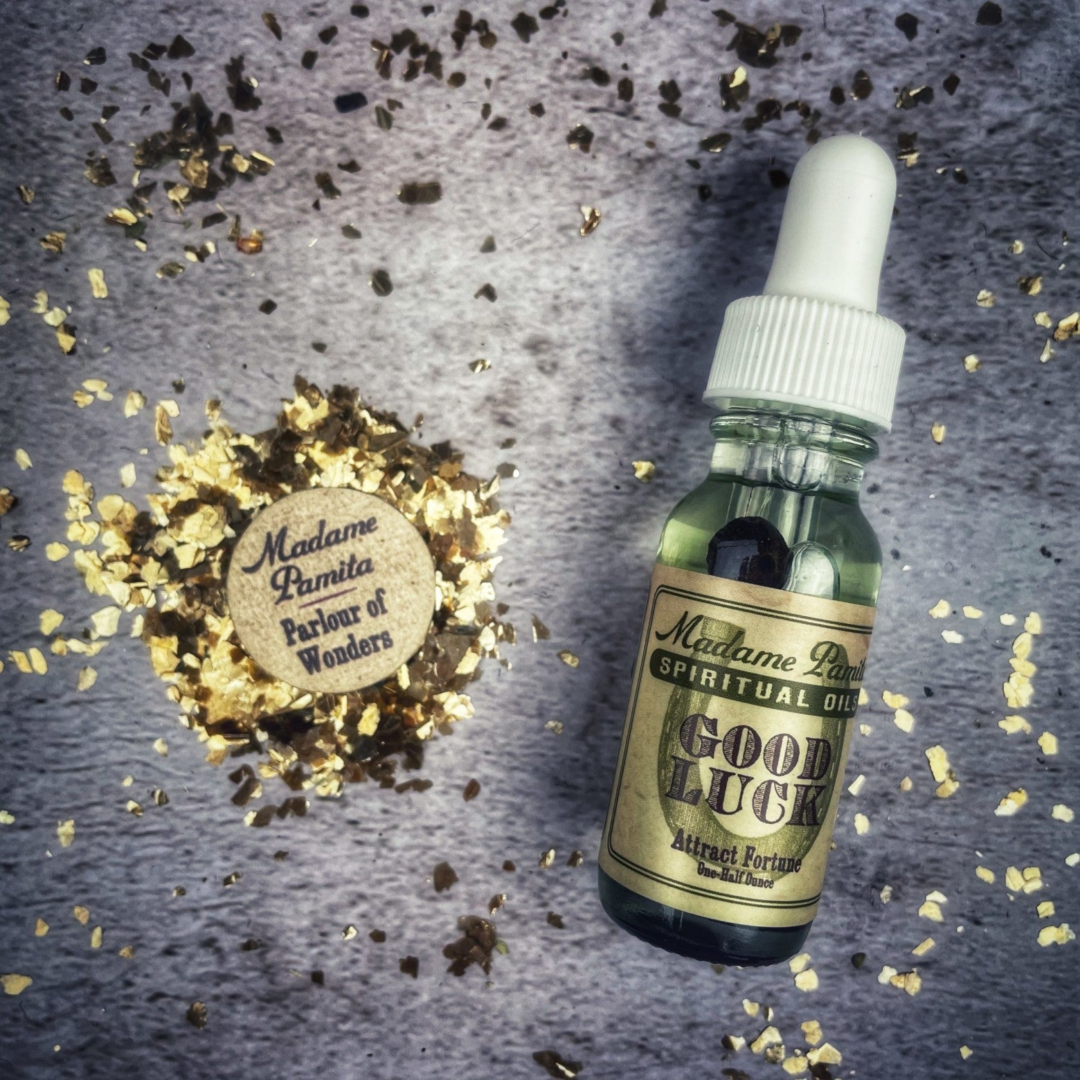 Bottle of Good Luck Oil by Madame Pamita from Parlour of Wonders, featuring a dark glass container with a label and decorative elements.