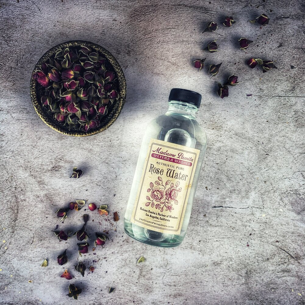 Bottle of Pure Rose Water by Madame Pamita from Parlour of Wonders, featuring clear liquid in a glass spray bottle.