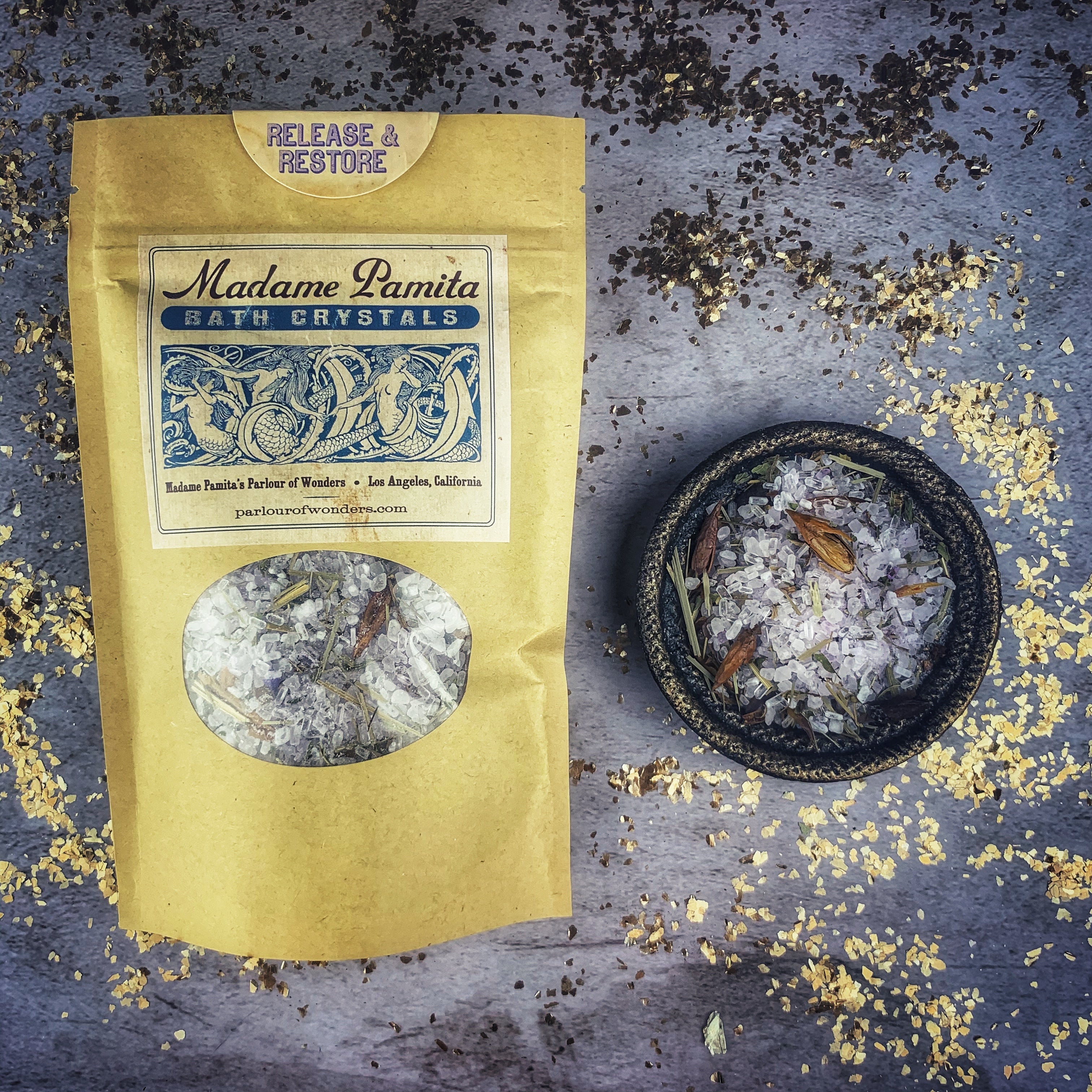 Small jar of Parlour of Wonders Release and Restore Bath Crystals with pink and purple bath salts for relaxation and rejuvenation.
