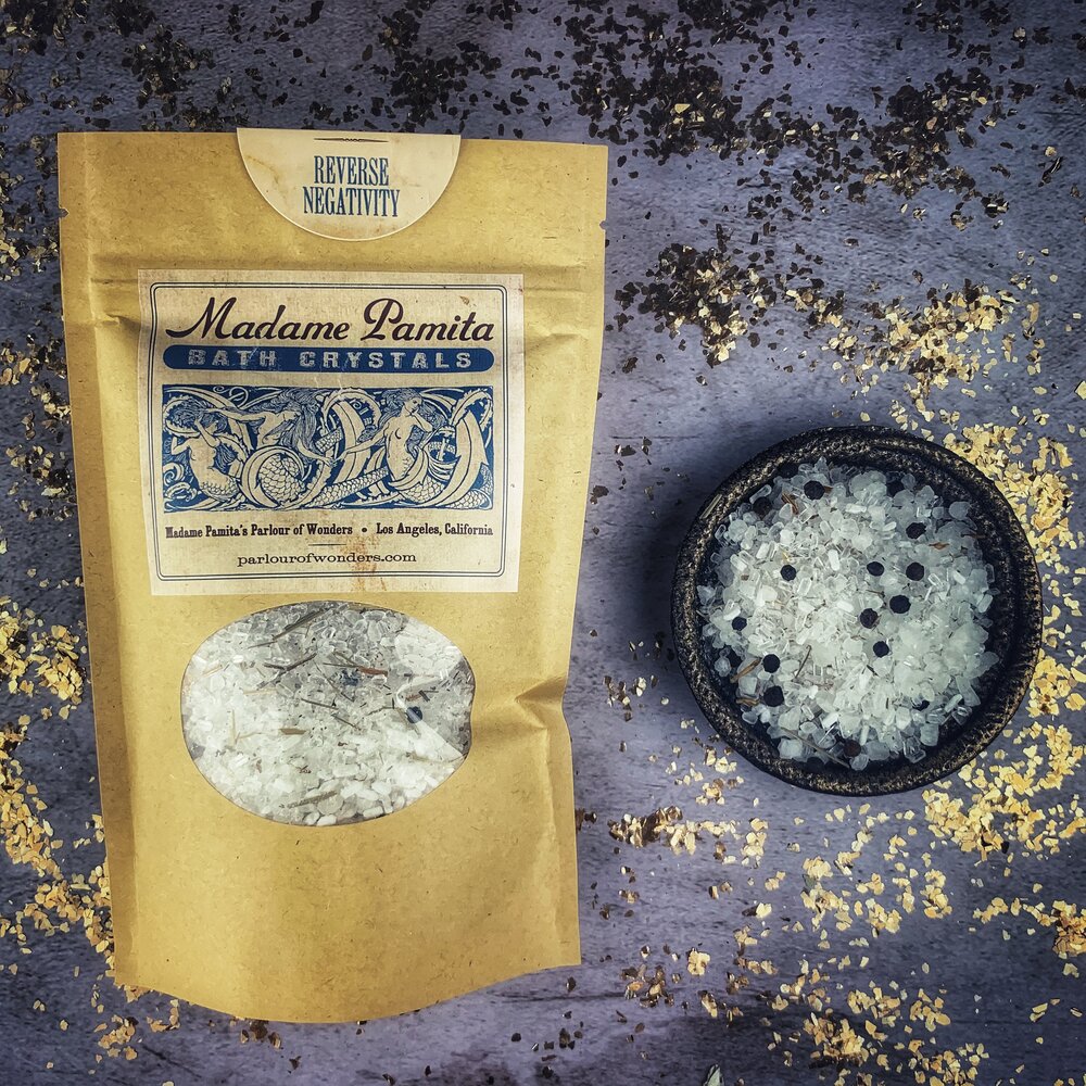 Small jar of Parlour of Wonders Reverse Negativity Bath Crystals with crystal accents and calming label design.
