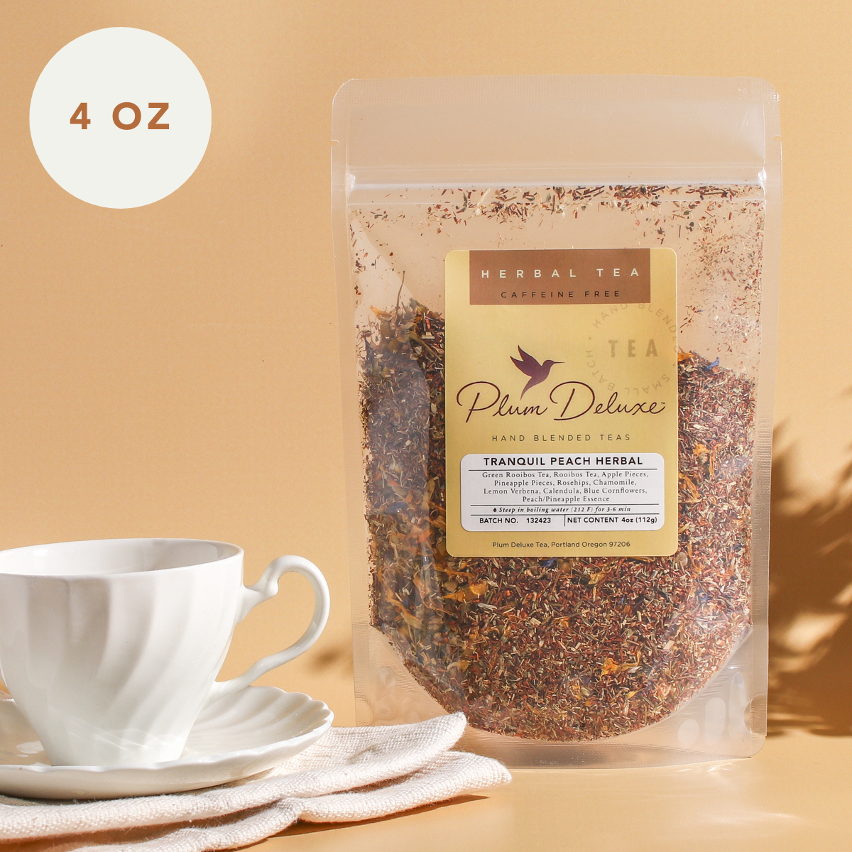 Tranquil Peach herbal tea by Plum Deluxe Tea in a 1 oz package with pineapple, peach, and chamomile ingredients.
