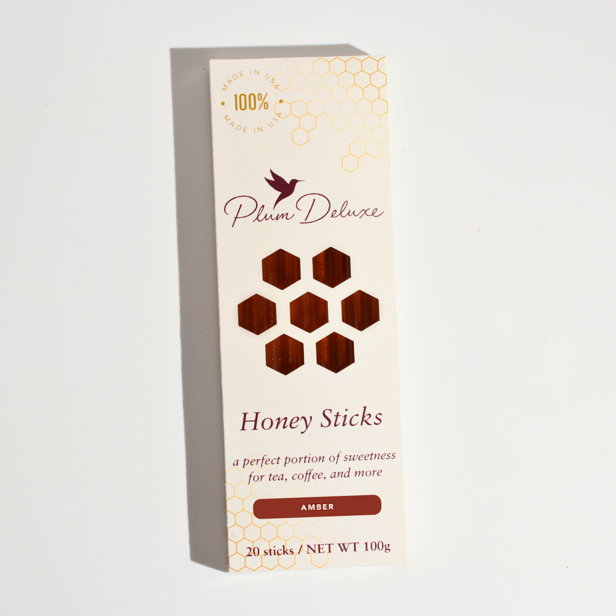 Amber Carrot Blossom Honey Sticks for Tea by Plum Deluxe Tea, natural honey sticks in clear packaging, ideal for sweetening tea.
