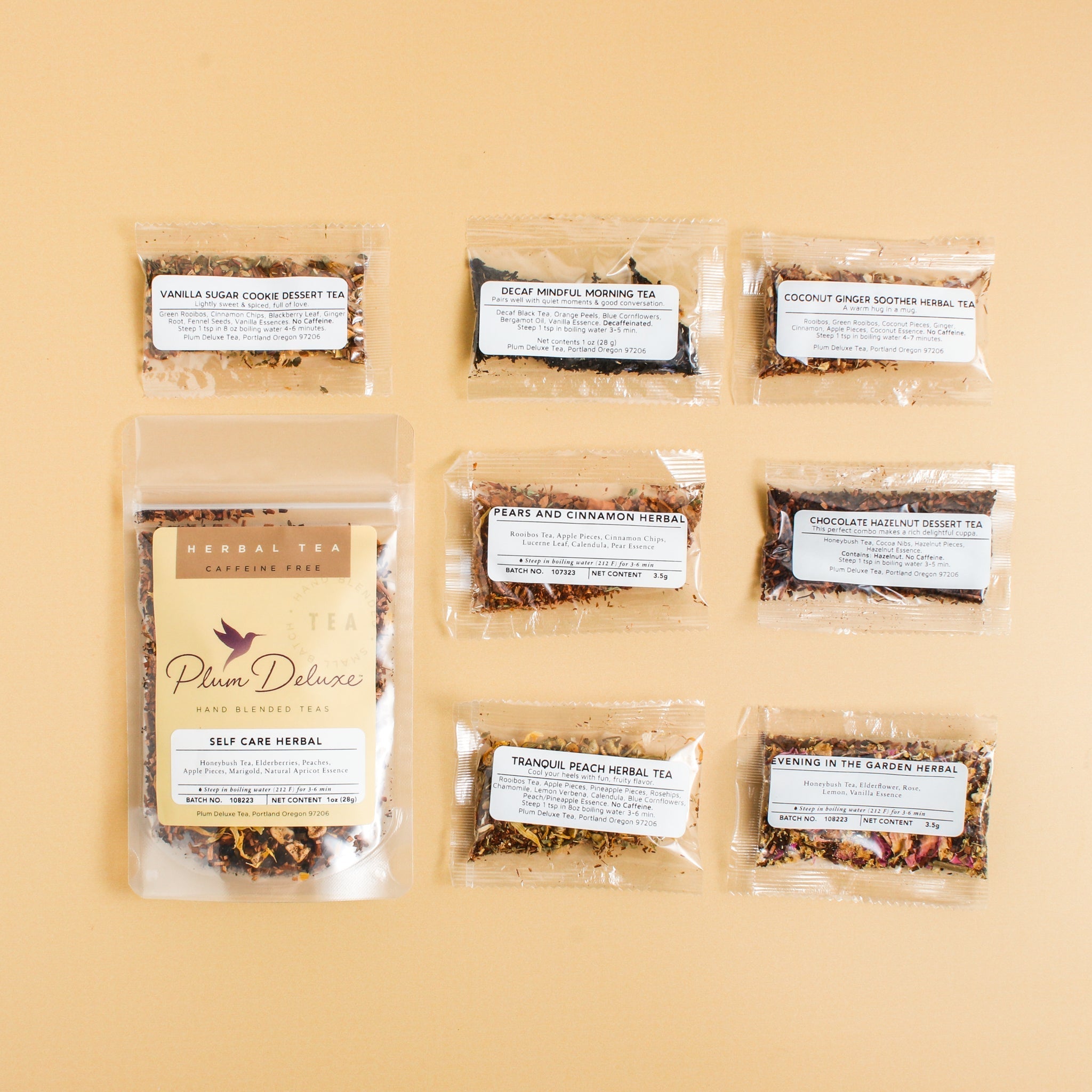 Assorted tea sampler set from Plum Deluxe Tea featuring various caffeine-free and best-selling tea blends in colorful packaging.