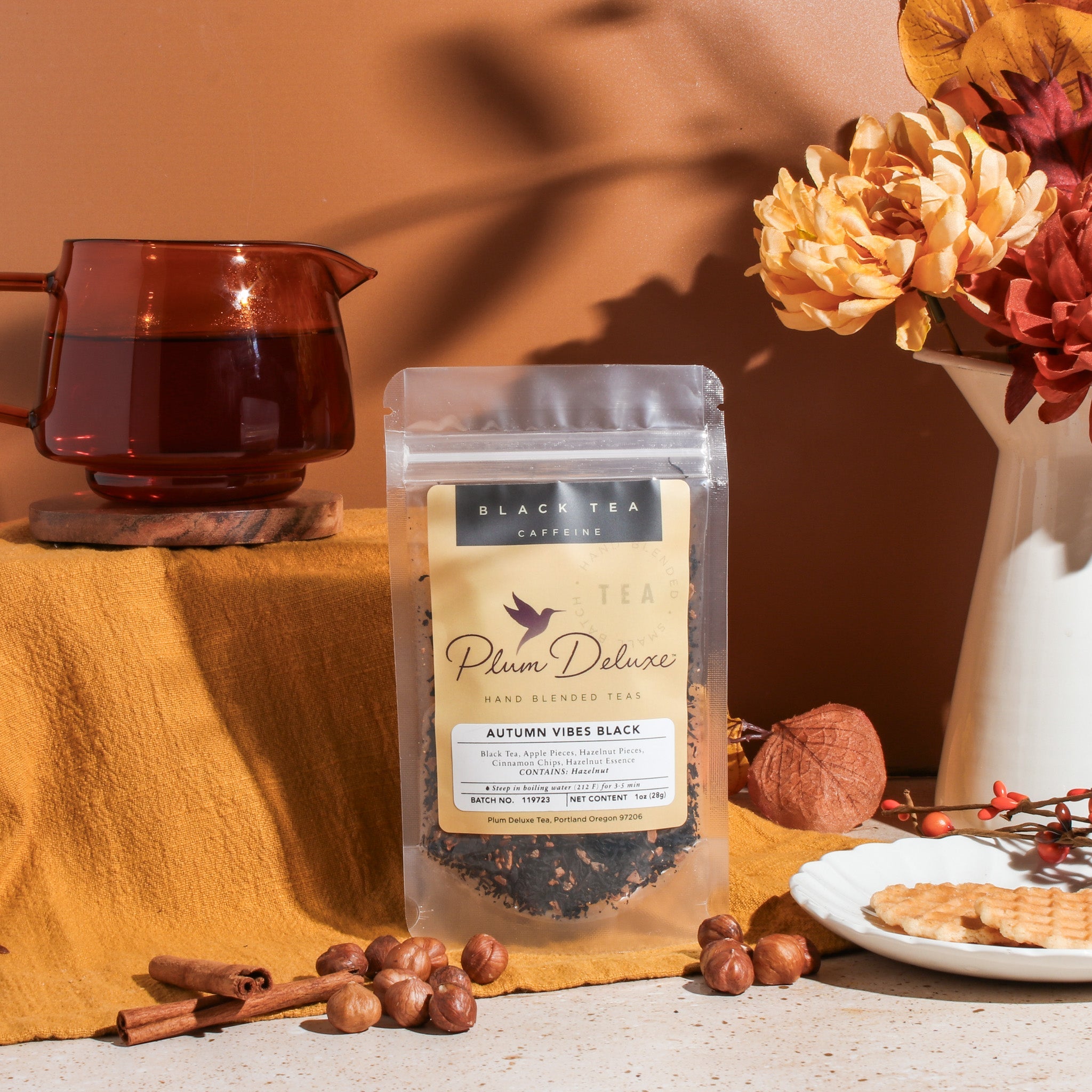 Black tea blend in a cup with cinnamon and hazelnut, showcasing Plum Deluxe's Autumn Vibes Black Tea flavor.
