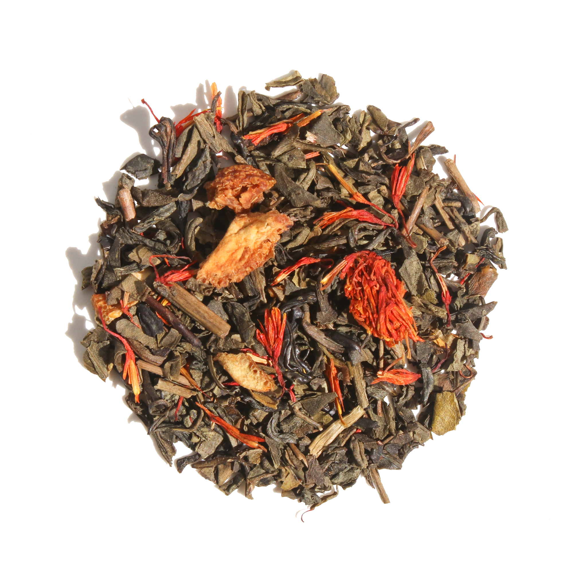Glass cup of Plum Deluxe Candied Orange Green Tea with orange slices and green tea leaves in a cozy setting.
