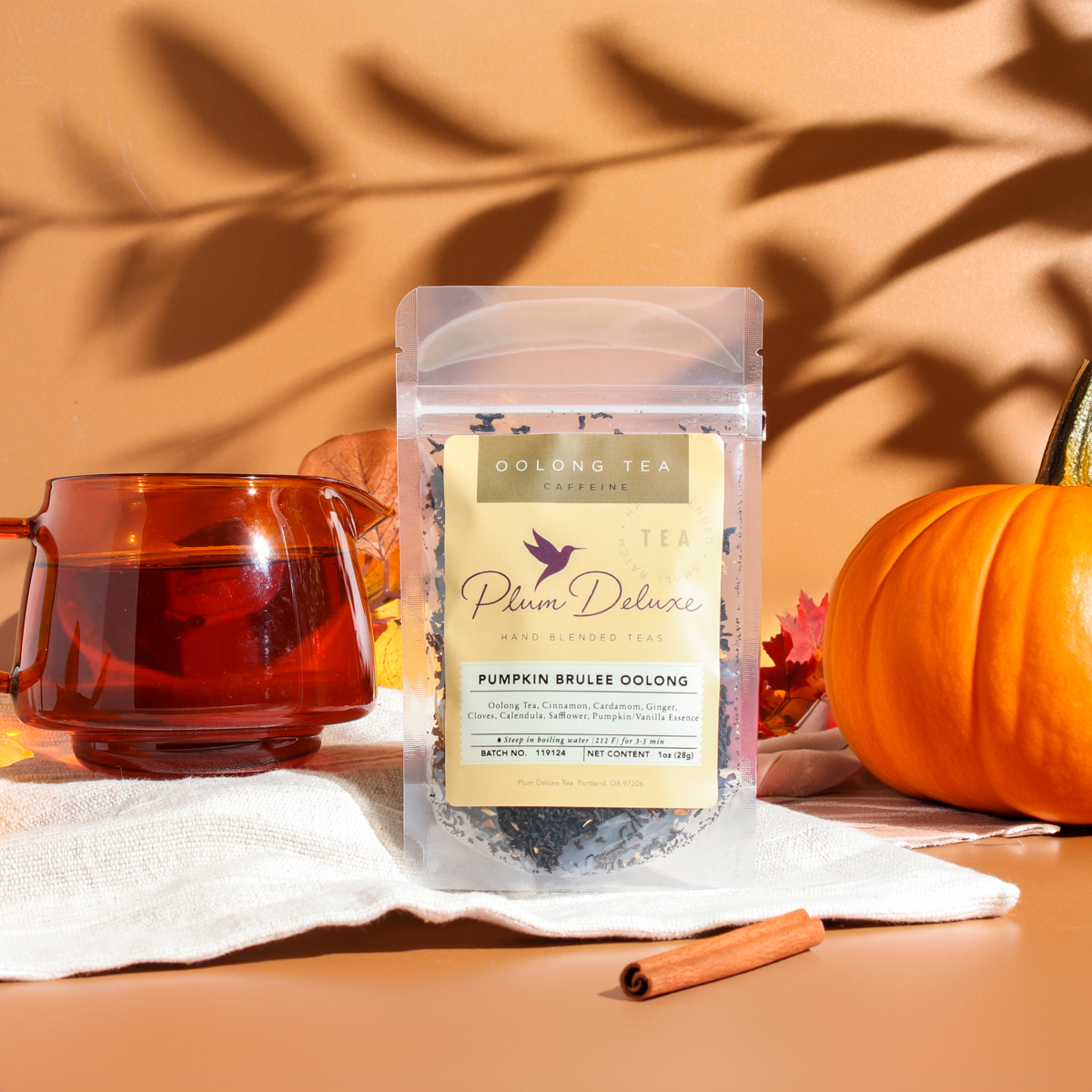 Cup of Pumpkin Spice Brulee Oolong Tea by Plum Deluxe Tea, showcasing a steaming brewed tea in a clear glass cup.