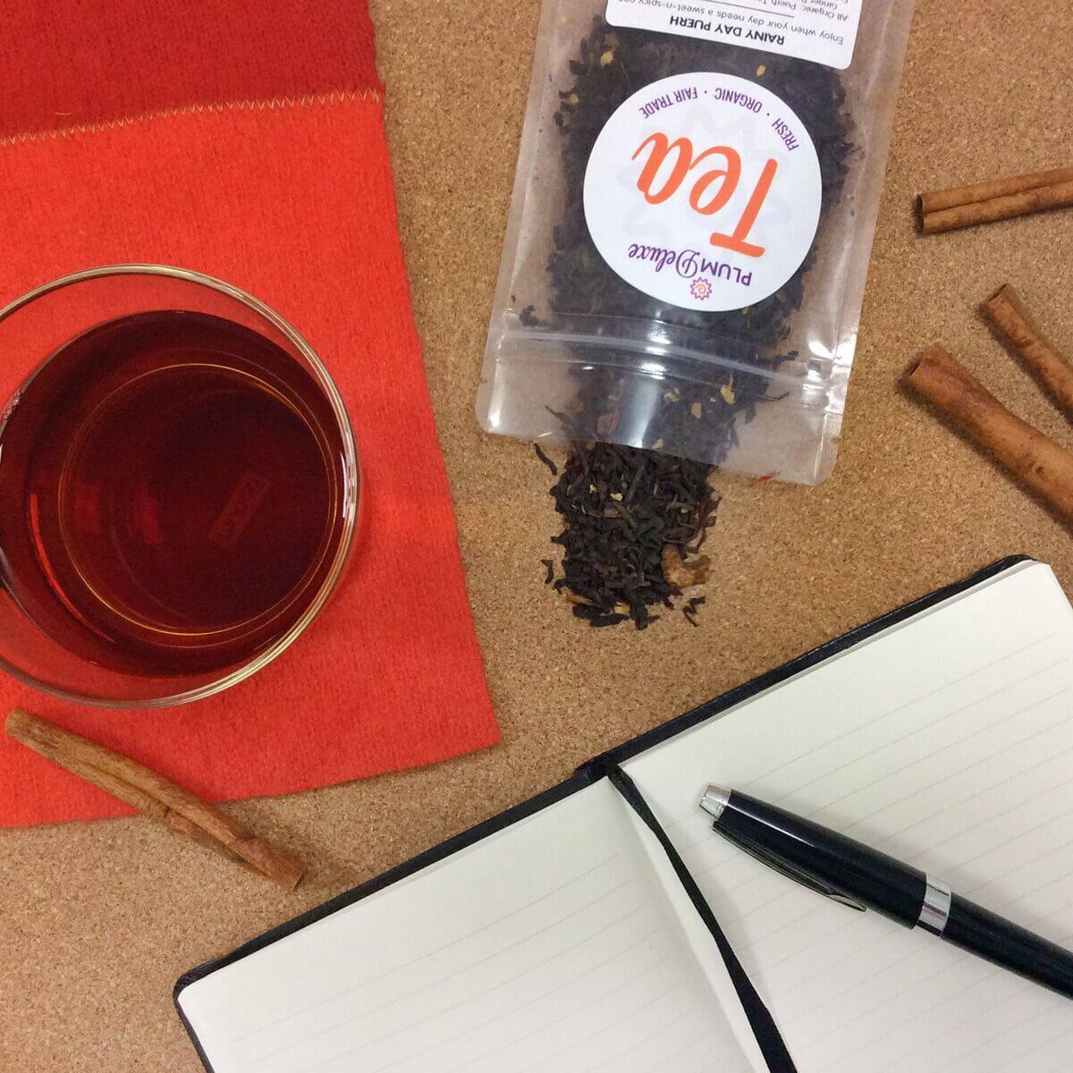 Cup of Rainy Day Puerh tea by Plum Deluxe Tea with rich, dark brewed tea in a cup, showcasing the sweet and spicy flavor profile.