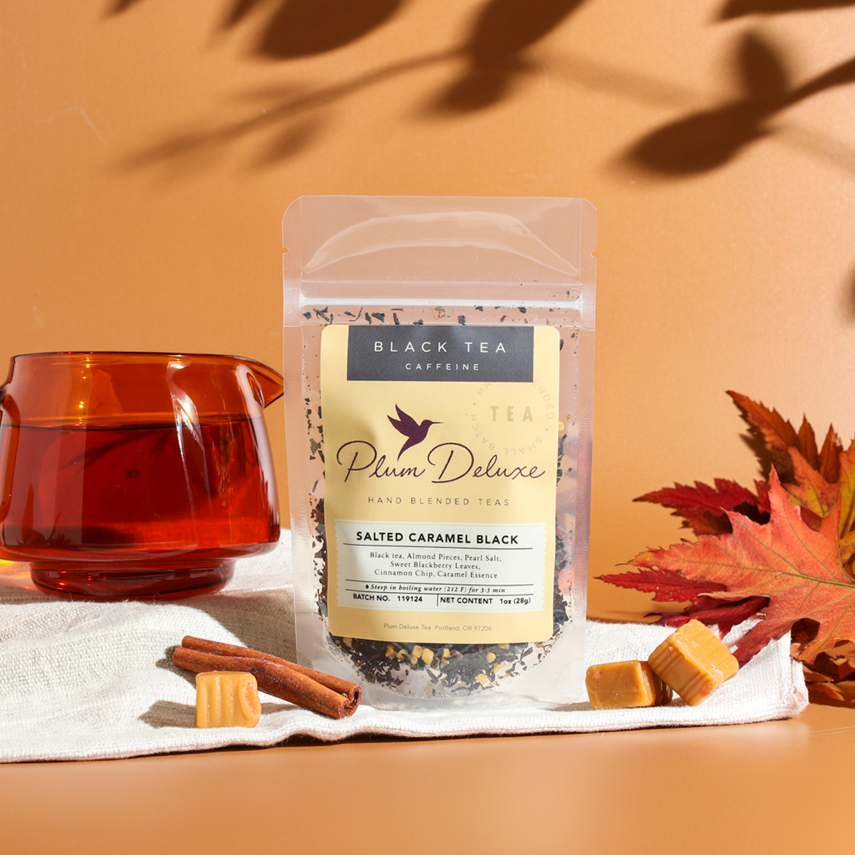 Plum Deluxe Salted Caramel Black Tea in a clear tea jar, showcasing the rich caramel-infused black tea leaves.