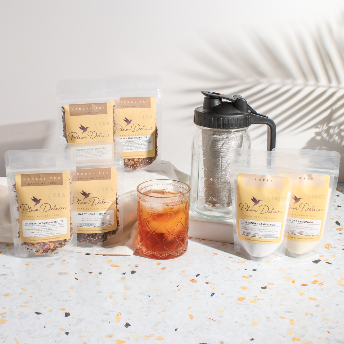 Plum Deluxe Tea Ultimate Iced Tea Bundle with tea, pitcher, and lemonade for refreshing cold beverages.