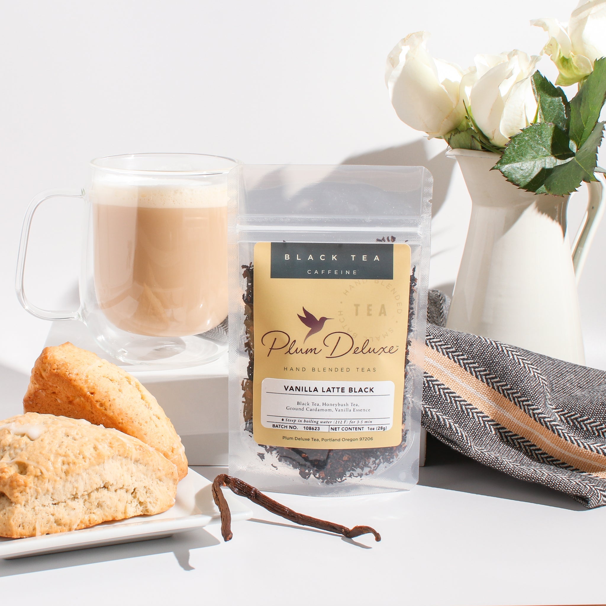 Vanilla Latte Tea by Plum Deluxe featuring a warm blend of cardamom and vanilla creme in a tea cup on a cozy table setting.