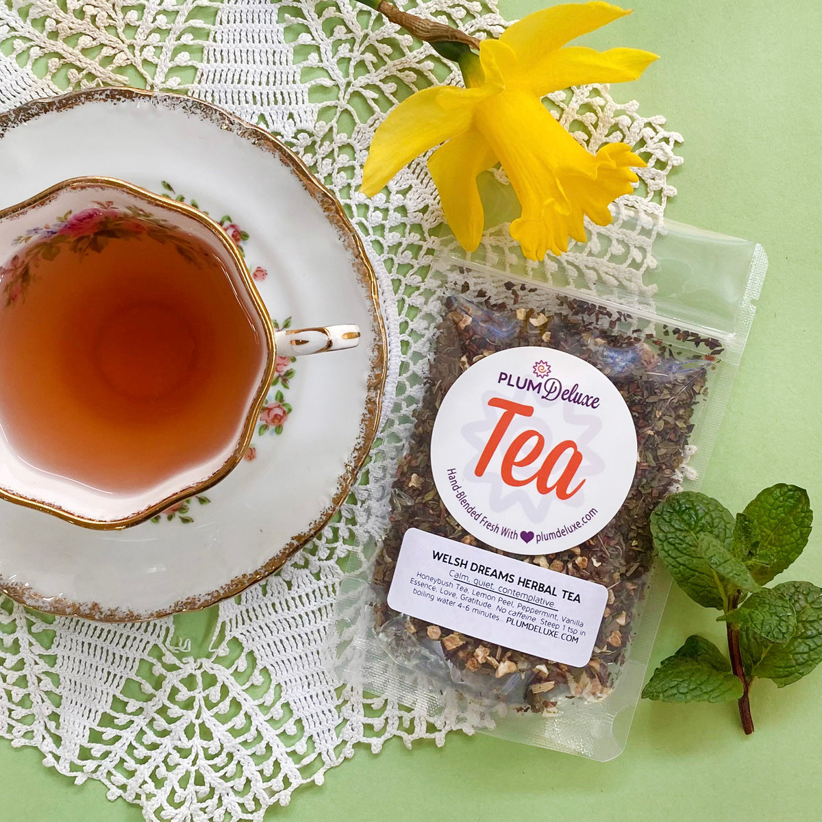 Welsh Dreams Herbal Tea by Plum Deluxe featuring vanilla, lemon, and mint flavors in a tea bag.