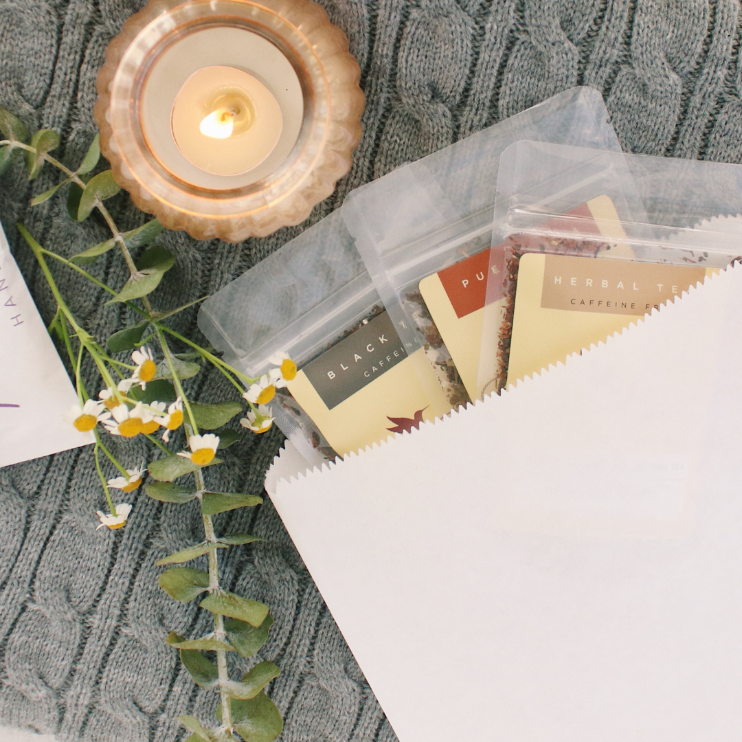 Assorted herbal teas from Plum Deluxe Tea Mystery Tea Trio, featuring caffeine-free herbal blends in colorful packaging.