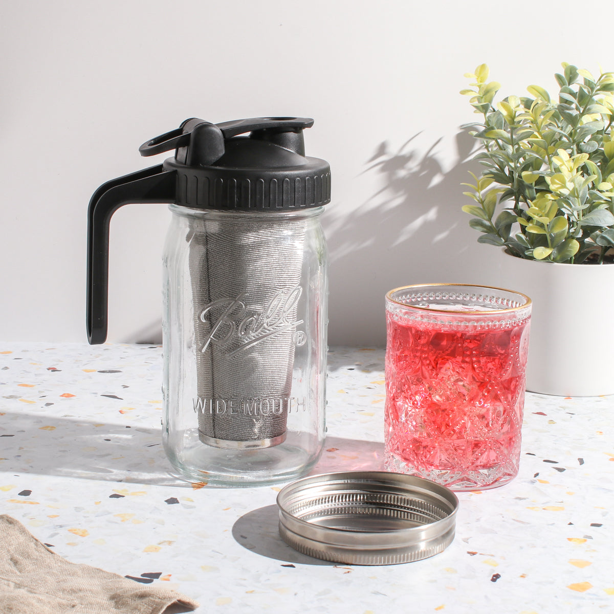 Maison Brew Cold Brew Iced Tea Mason Jar by Plum Deluxe Tea, featuring a glass jar with a lid and built-in strainer for cold brewing.