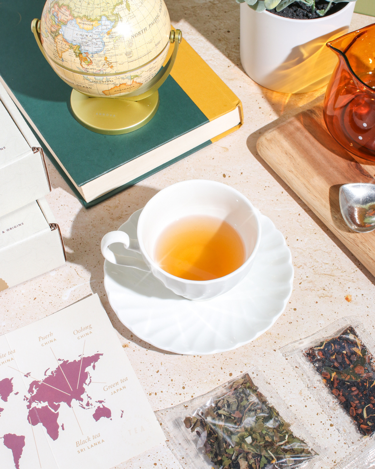Plum Deluxe Tea 2023 World of Tea Herbal Exclusives box featuring pear, elderflower, and red rooibos herbal tea blend.
