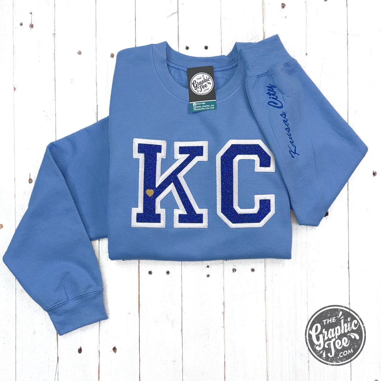 Powder blue KC Glitter applique crewneck sweatshirt by The Graphic Tee featuring a glittering Kansas City design.