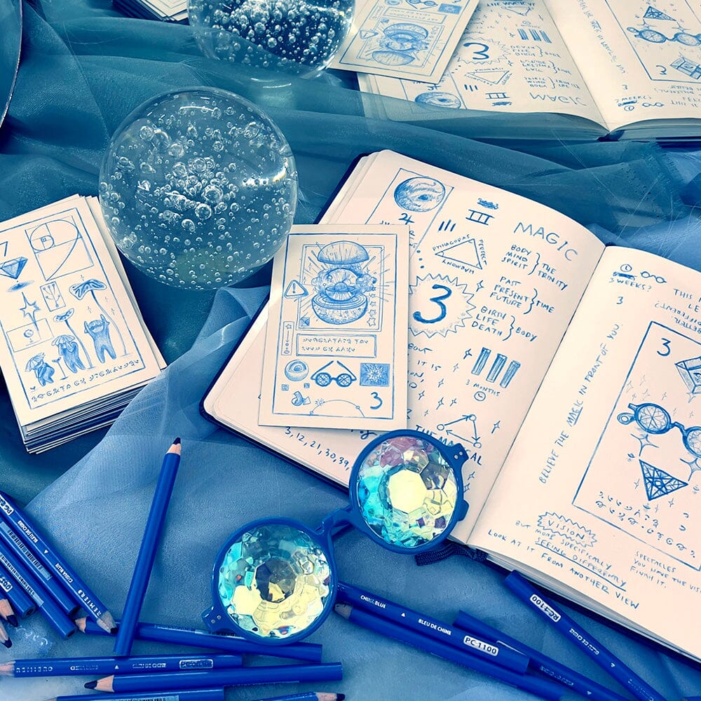 Prisma Visions The Cerulean Sequence deck featuring vibrant blue and teal art cards laid out on a table.