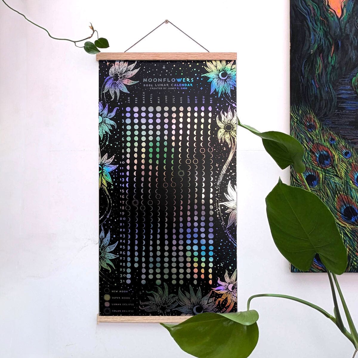 White print of the Moonflowers 2026 Lunar Calendar by Prisma Visions, featuring moon phases and celestial illustrations on paper.