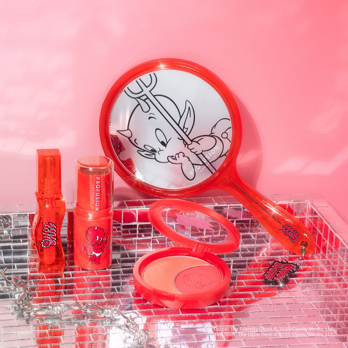 Profusion Cosmetics Hot Stuff The Little Devil handheld mirror with red handle and decorative devil design, perfect accessories for makeup.