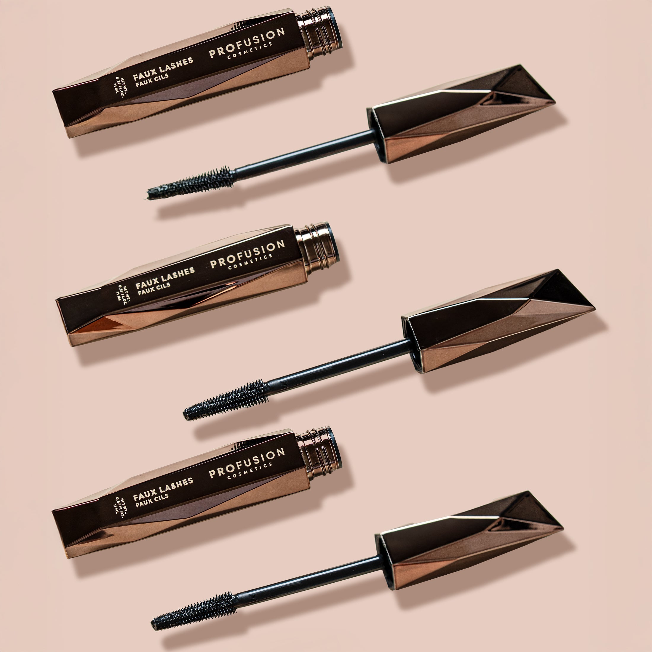 Black faux lashes and lengthening volumizing mascara from Profusion Cosmetics, showcasing the product's applicator and lash enhancement.