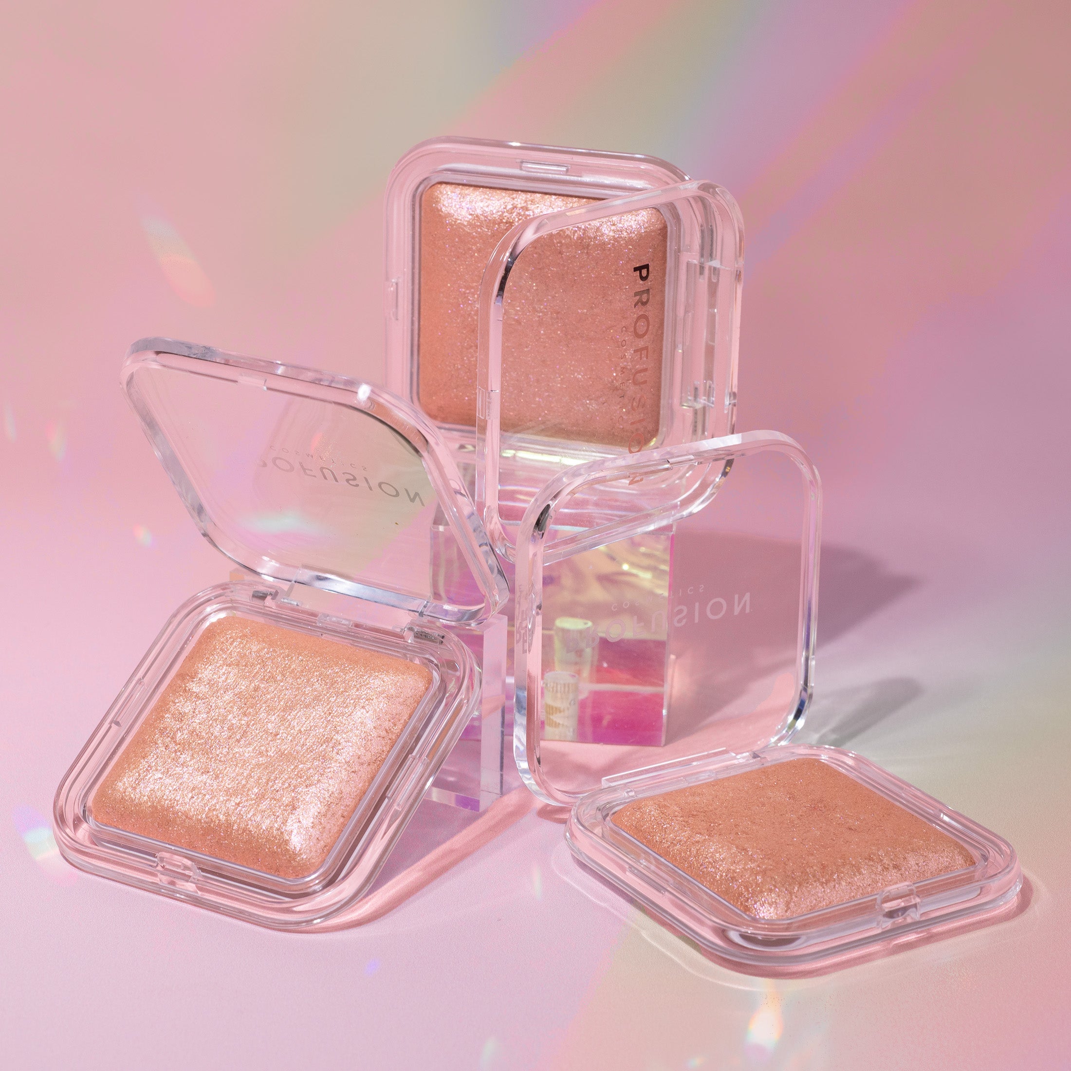 Profusion Cosmetics Holo Beam holographic highlighter on face, showcasing its shiny, iridescent finish for a luminous glow.