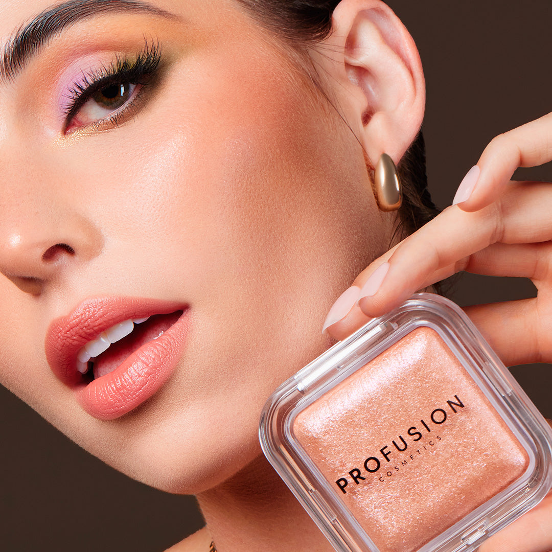 Profusion Cosmetics Holo Beam holographic highlighter on face, showcasing radiant, iridescent glow for a luminous makeup look.
